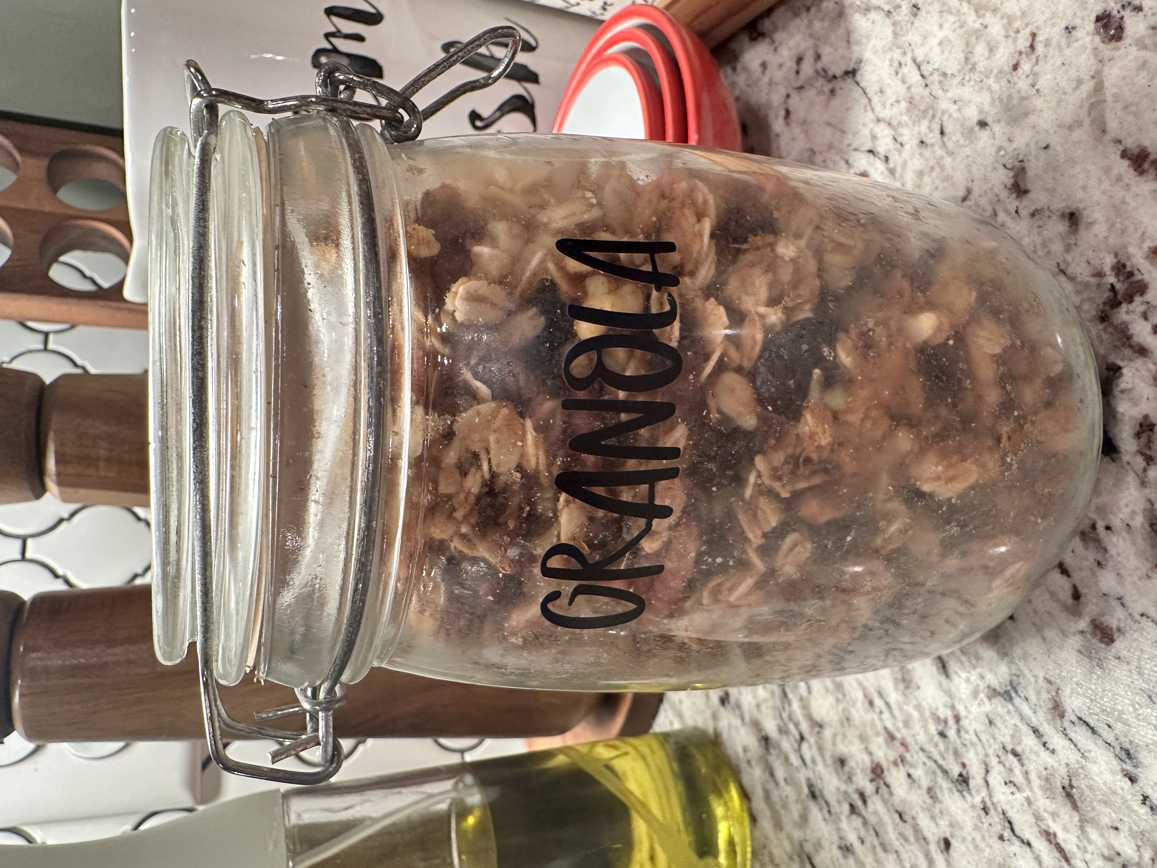 Completed granola in a jar that says "Granola"