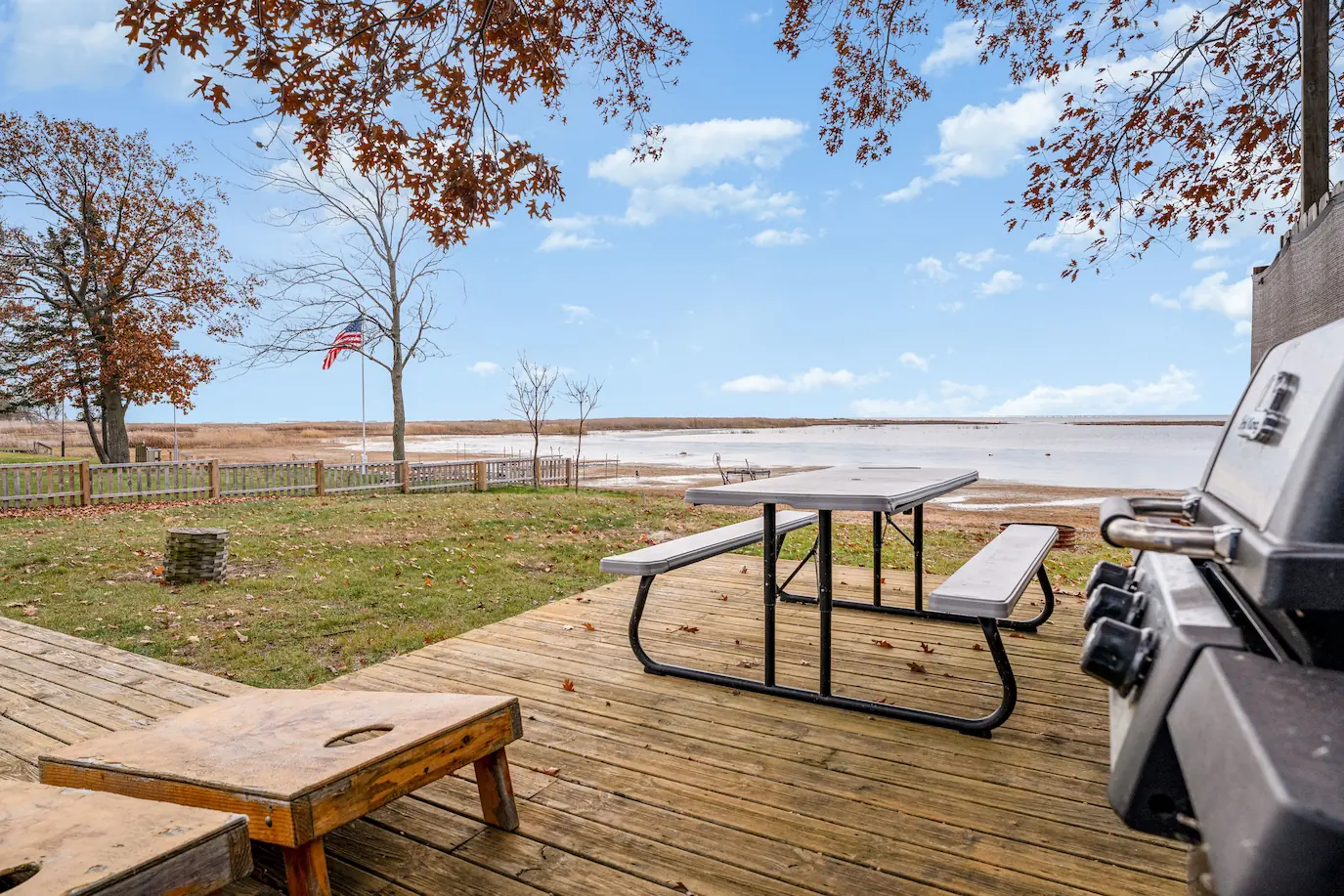 Relaxing outdoor deck chairs and fire pit overlooking the lake