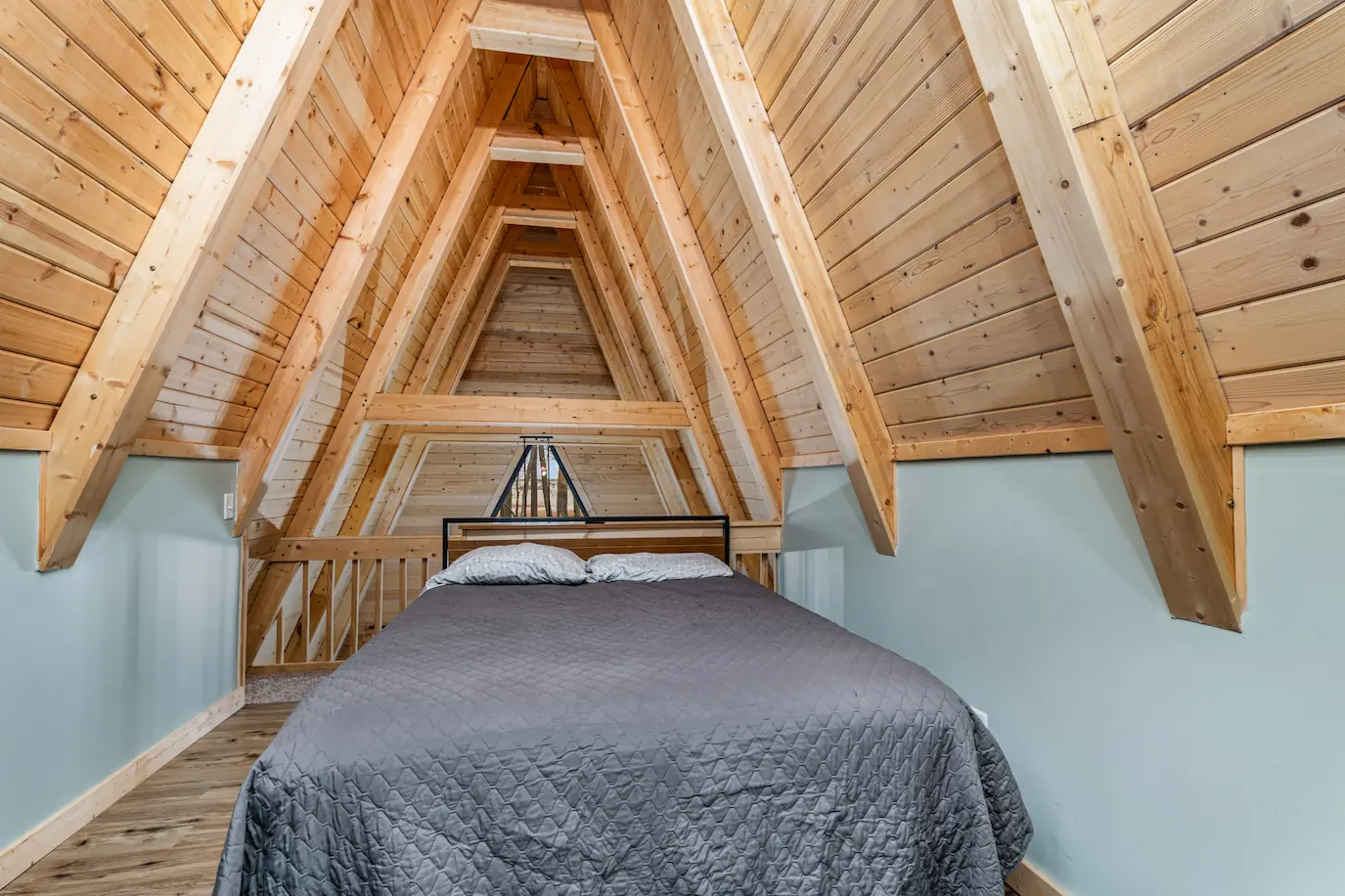 Charming upper loft bedroom space under the A-Frame ceiling