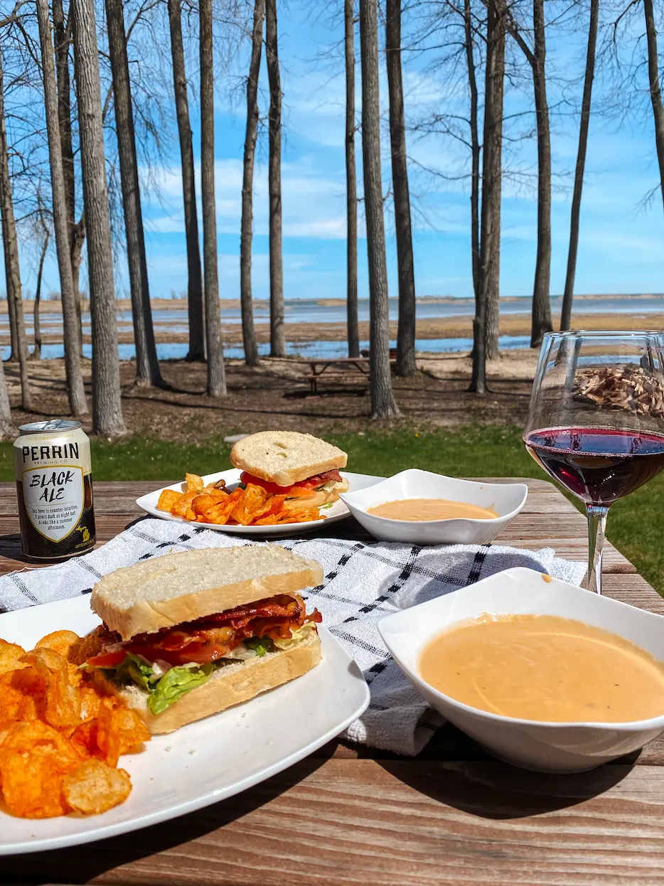 Returning guests enjoying a nice meal with beer and wine at Lake Huron Cabin Rentals