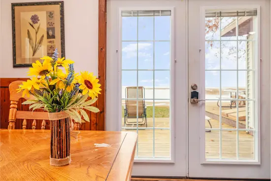 Cabin interior with sunflowers looking out at Lake Huron