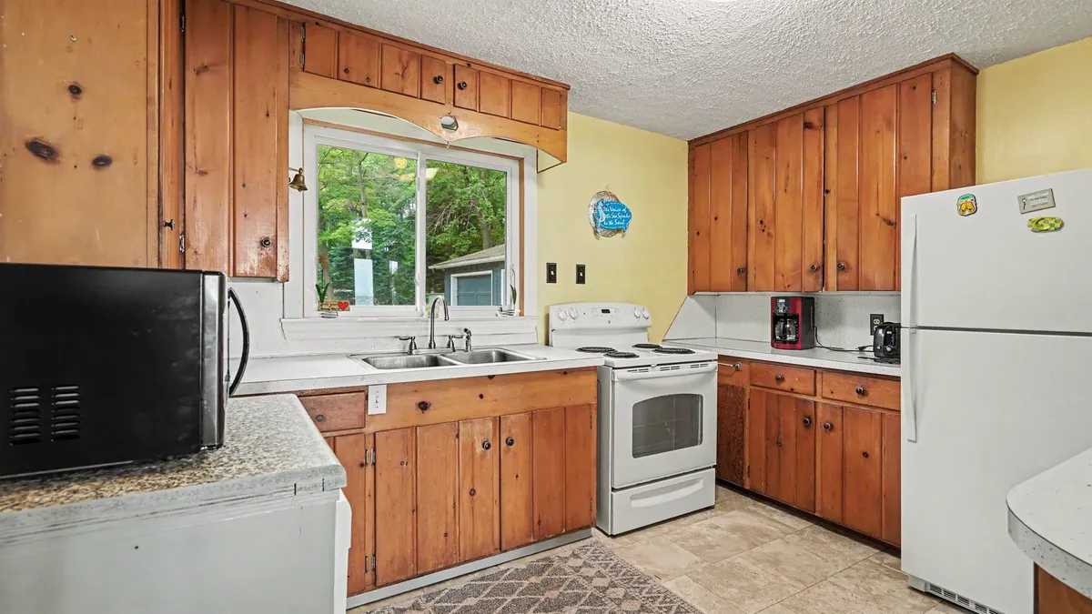 Full kitchen with wood cabinets at Granny's Cabin