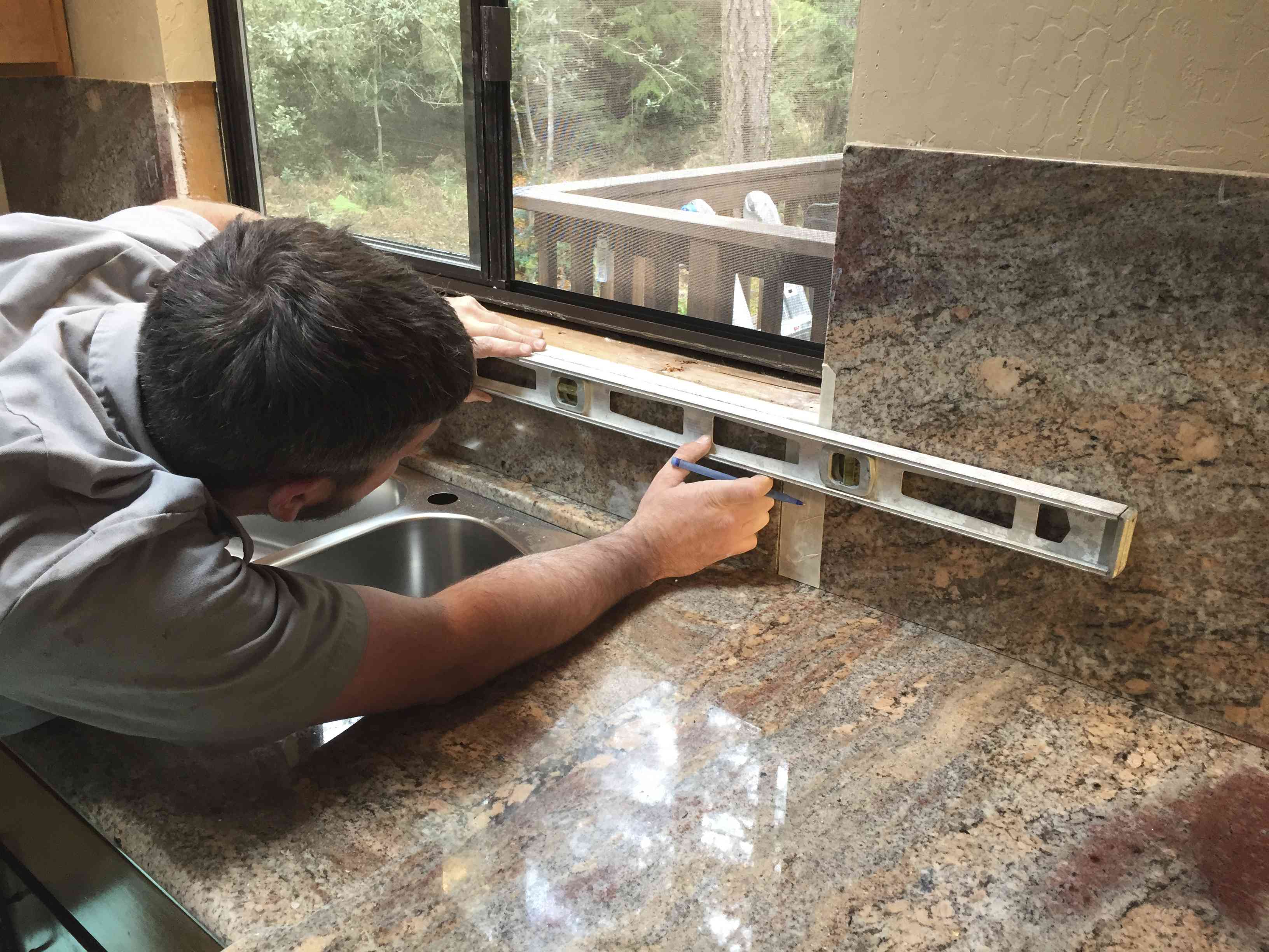cabinet expert measuring the granite countertop