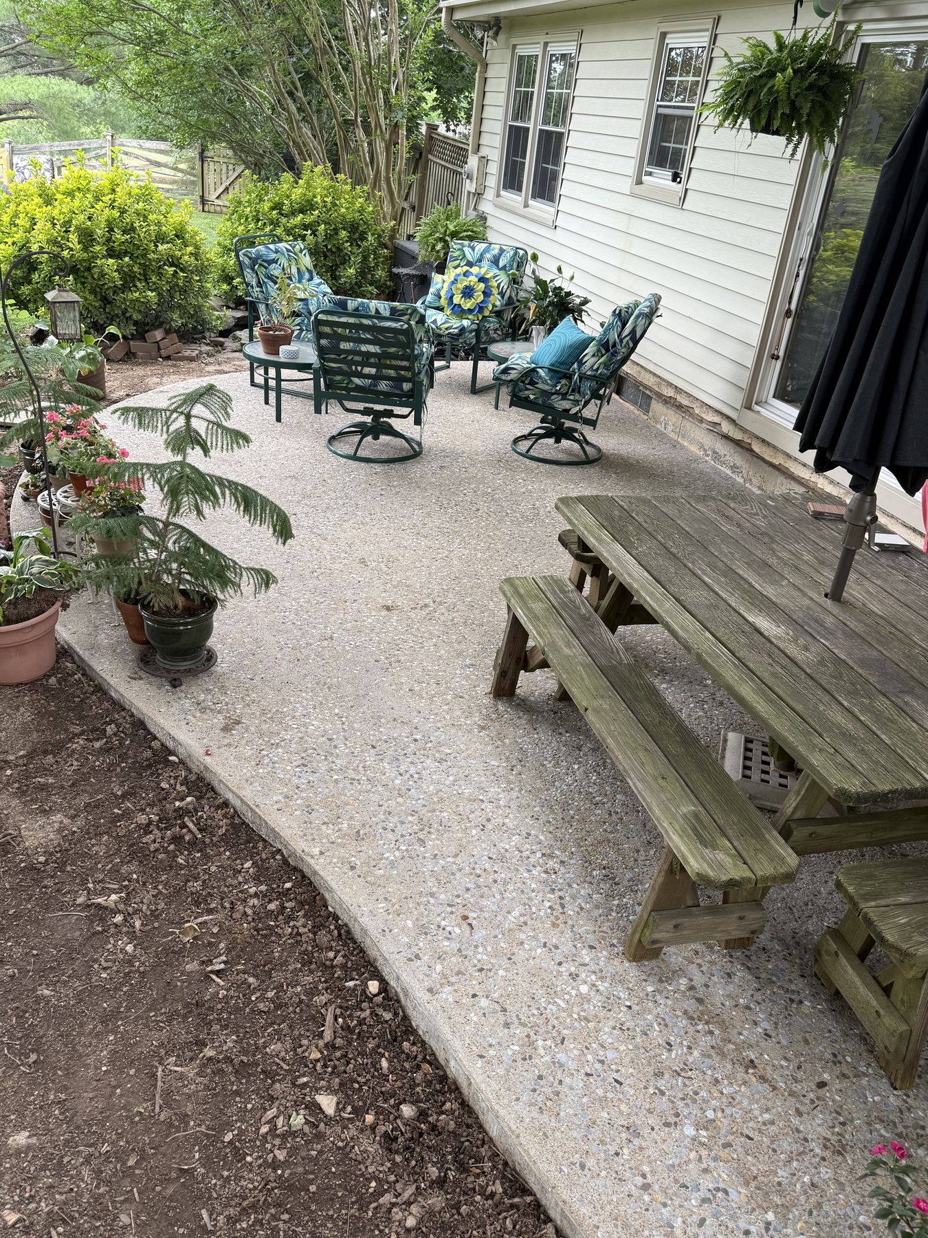 Newly poured concrete patio with seating area, Loudoun County backyard remodel