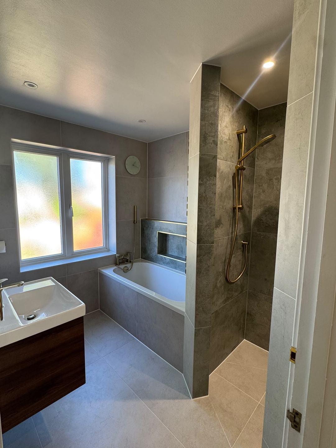 Bathroom by Novo Plumbing with a bath, a walk-in shower and brushed brass fittings