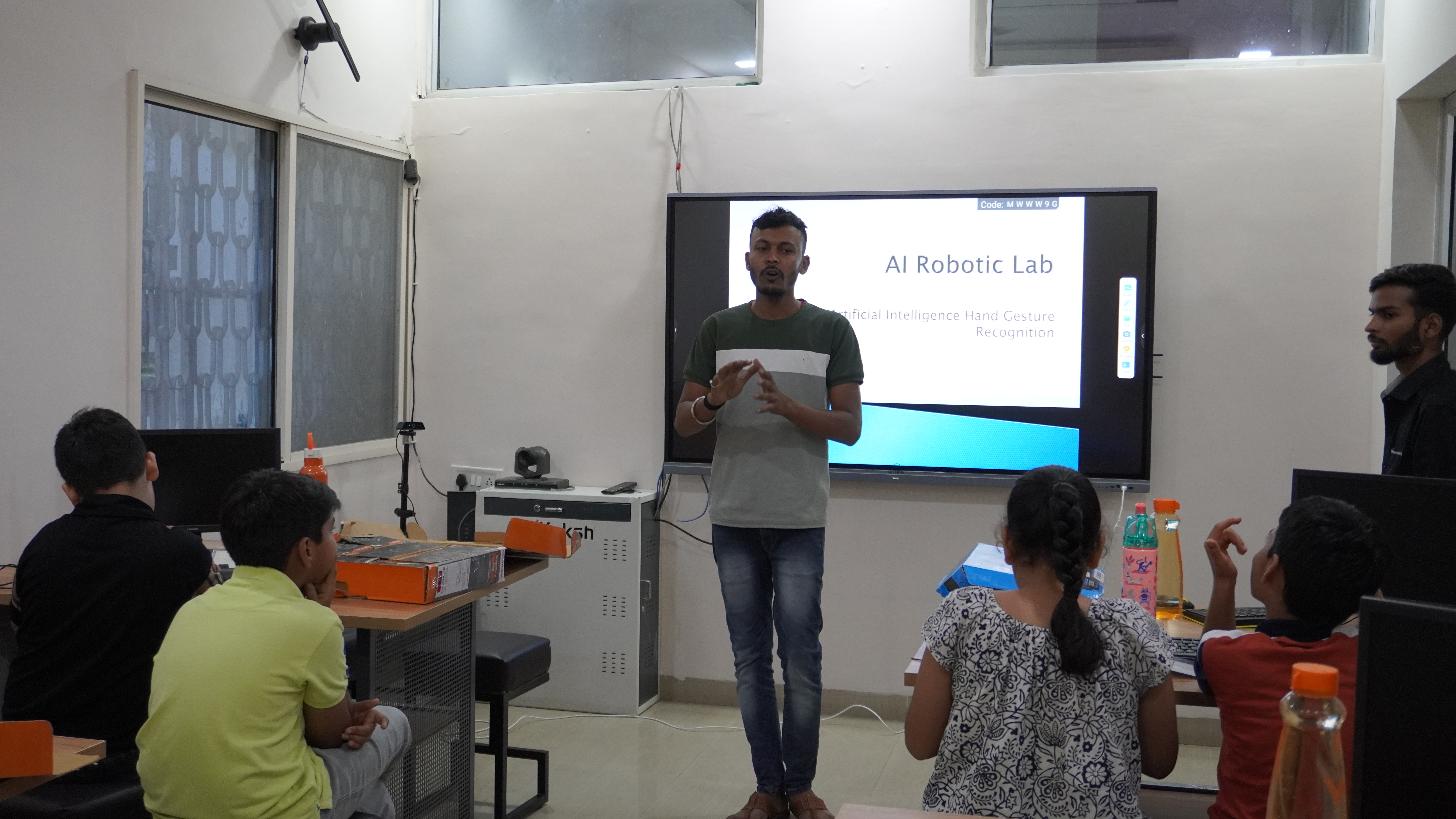 A full-time Grobots trainer leading a managed lab session for students