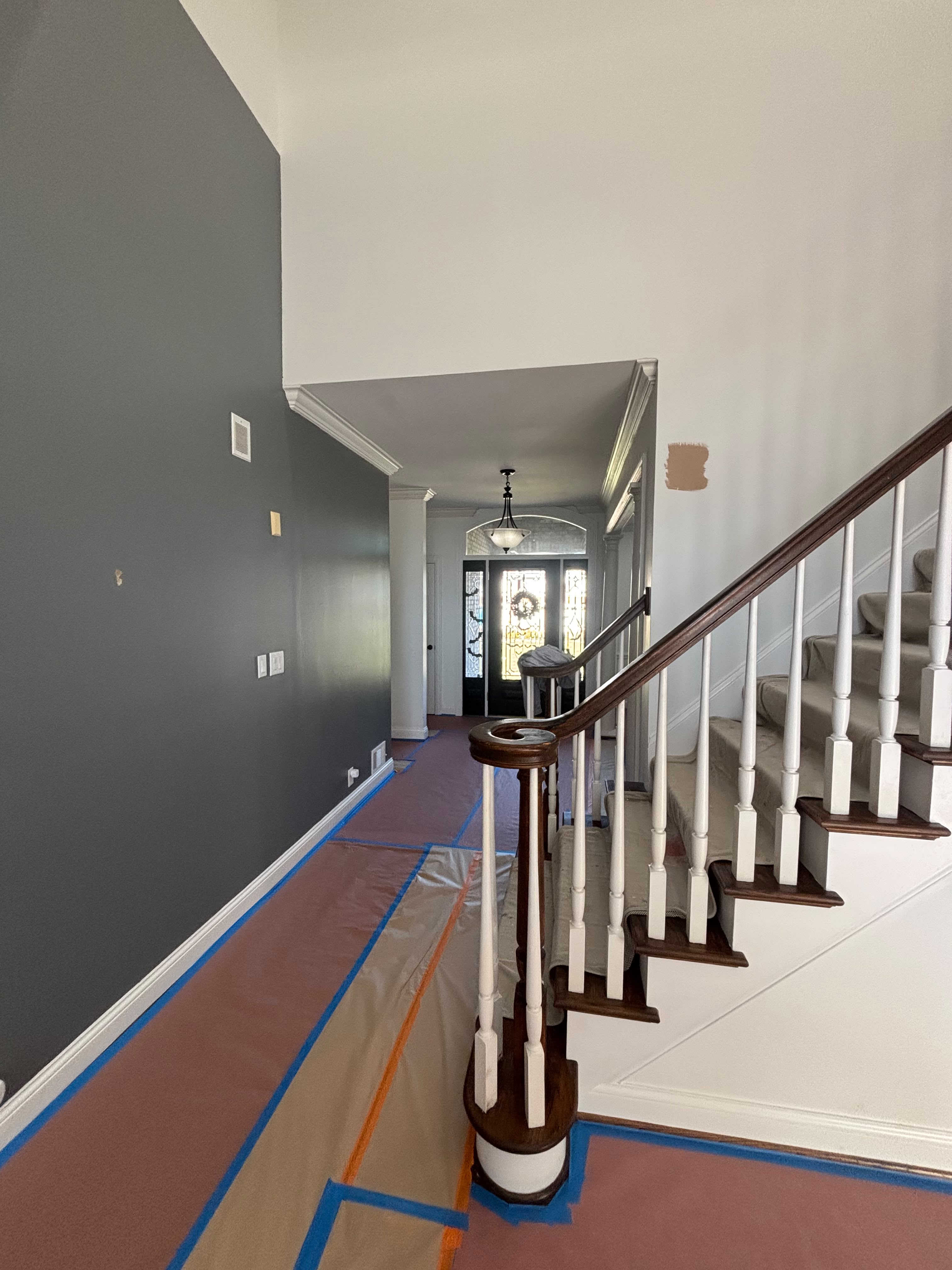 Painted foyer and staircase with crisp trim detail in Louisville KY by ECH Professional Painting