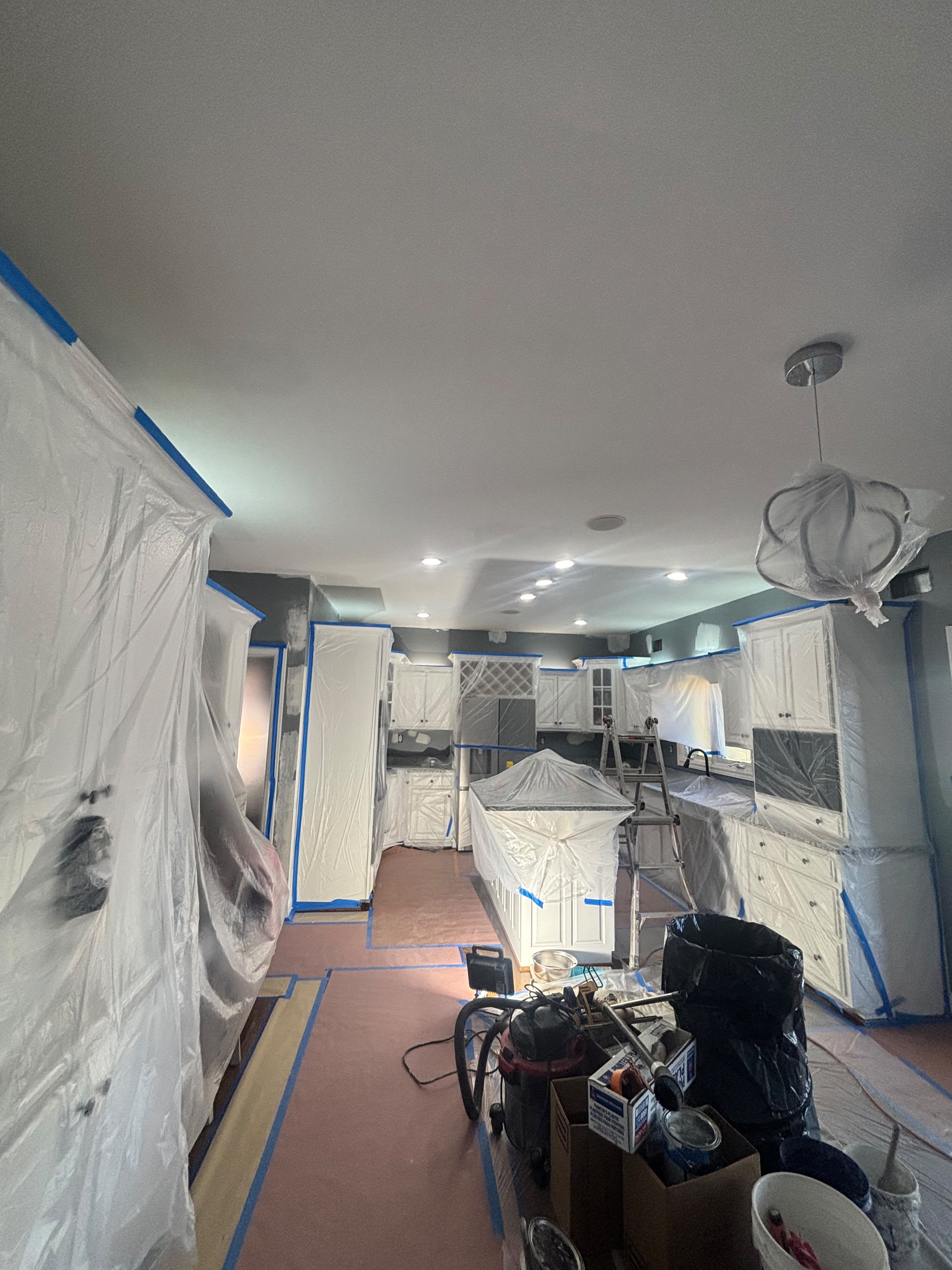 Kitchen masked and prepped before cabinet spray painting by ECH Professional Painting