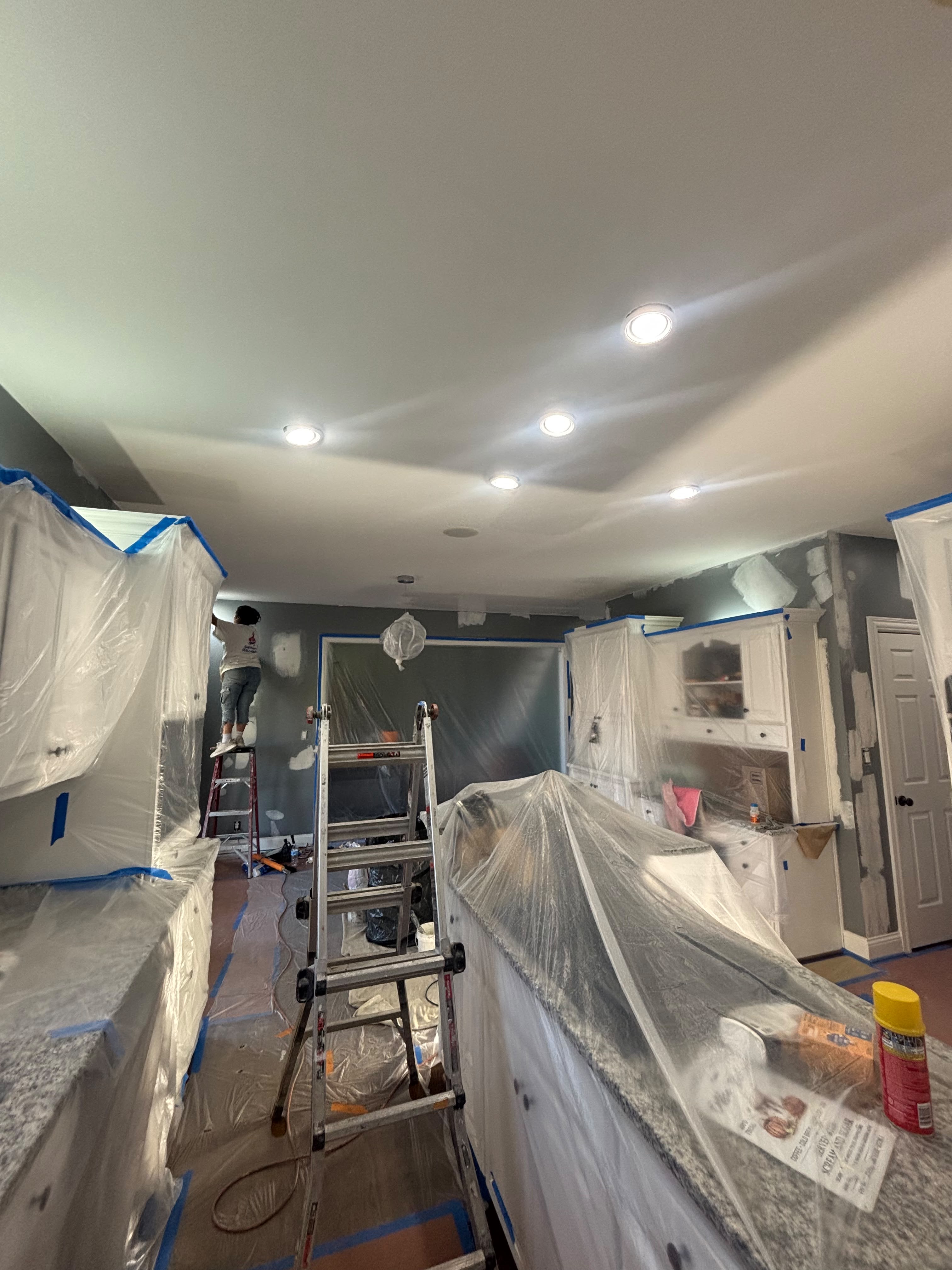 Kitchen masked and prepped for cabinet spray painting in Louisville KY by ECH Professional Painting