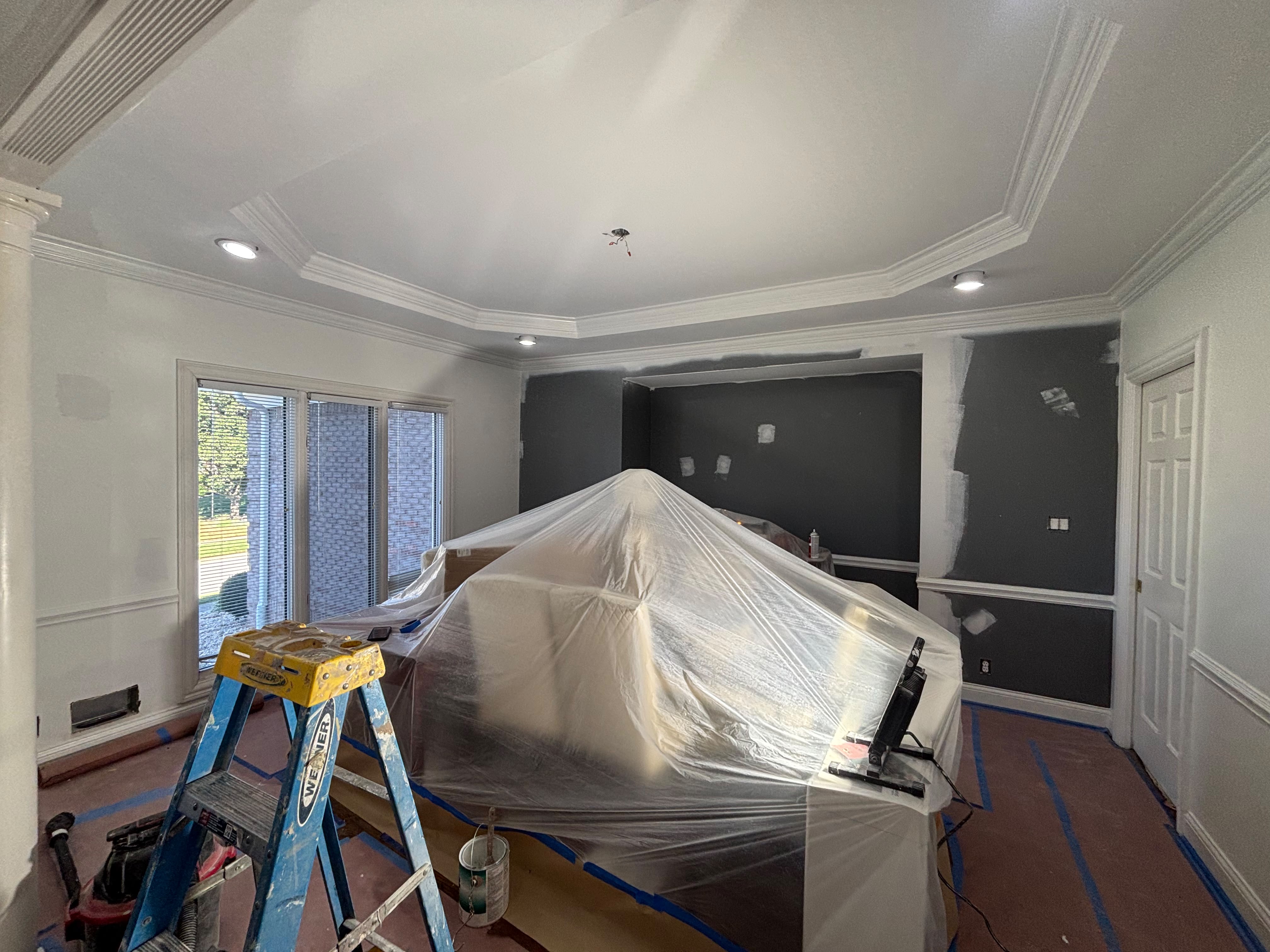 Room protected with plastic sheeting during interior painting in Louisville KY by ECH Professional Painting