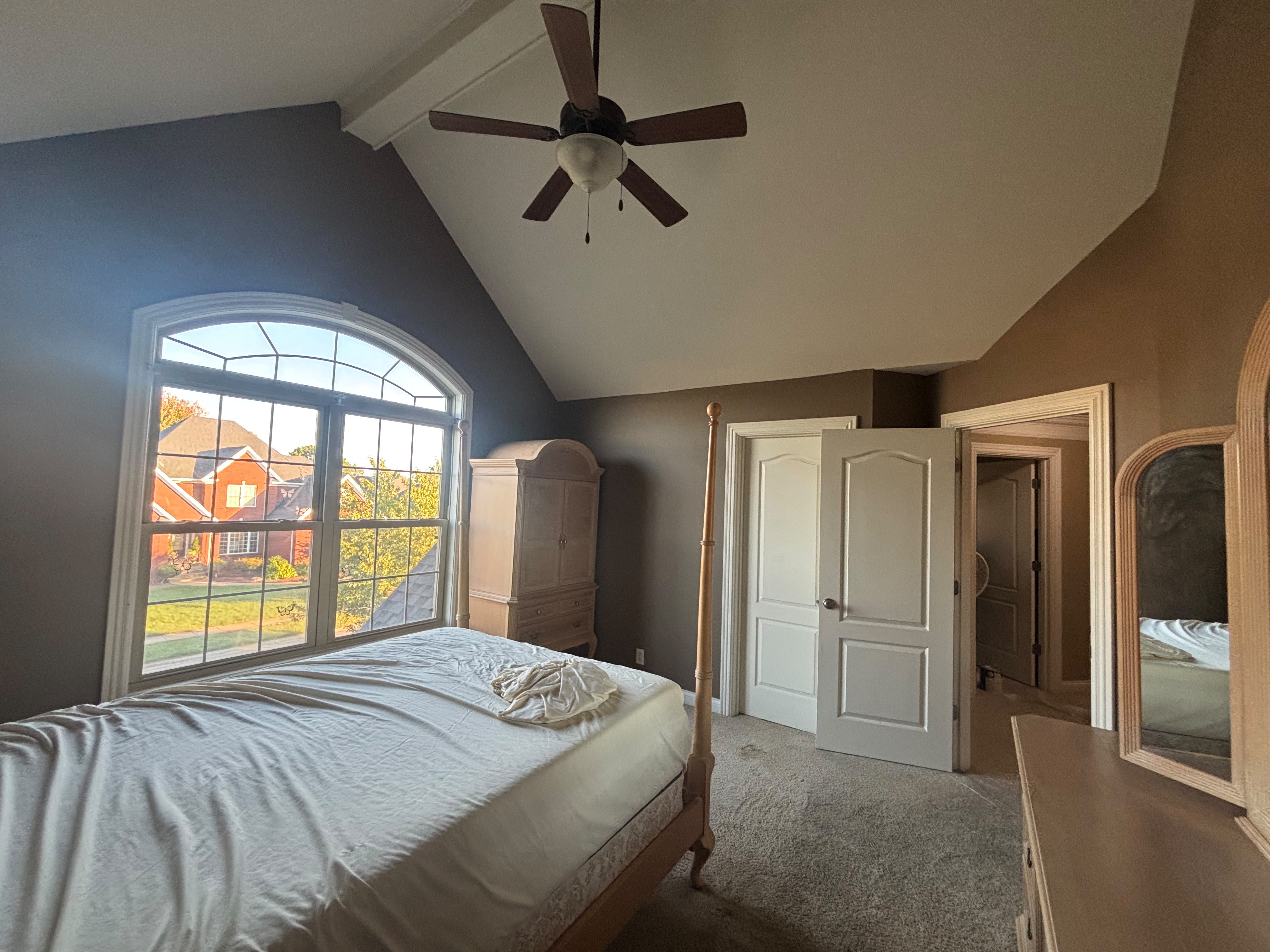 Finished bedroom interior painting with neutral color and white trim in Louisville KY by ECH Professional Painting