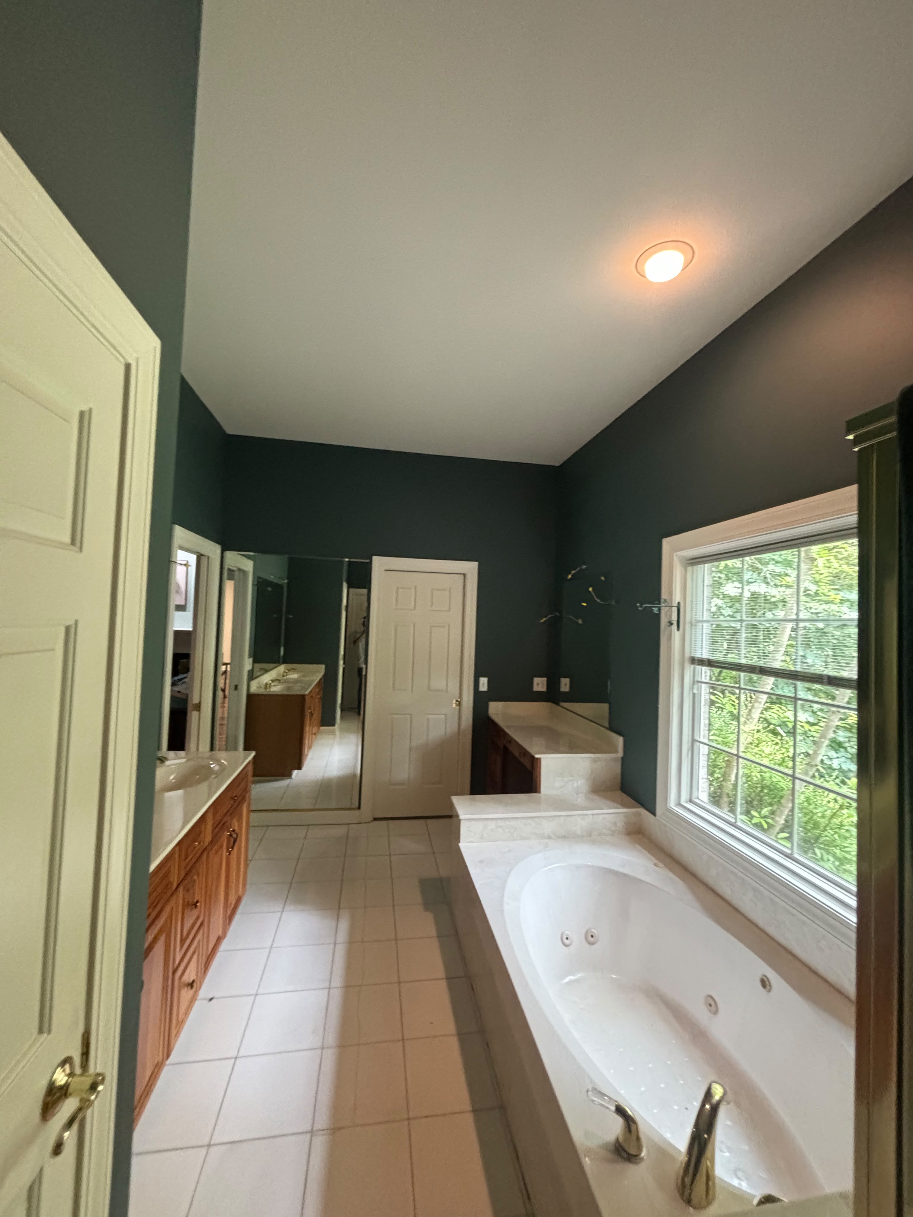 Completed bathroom interior repaint with clean lines in Louisville KY by ECH Professional Painting