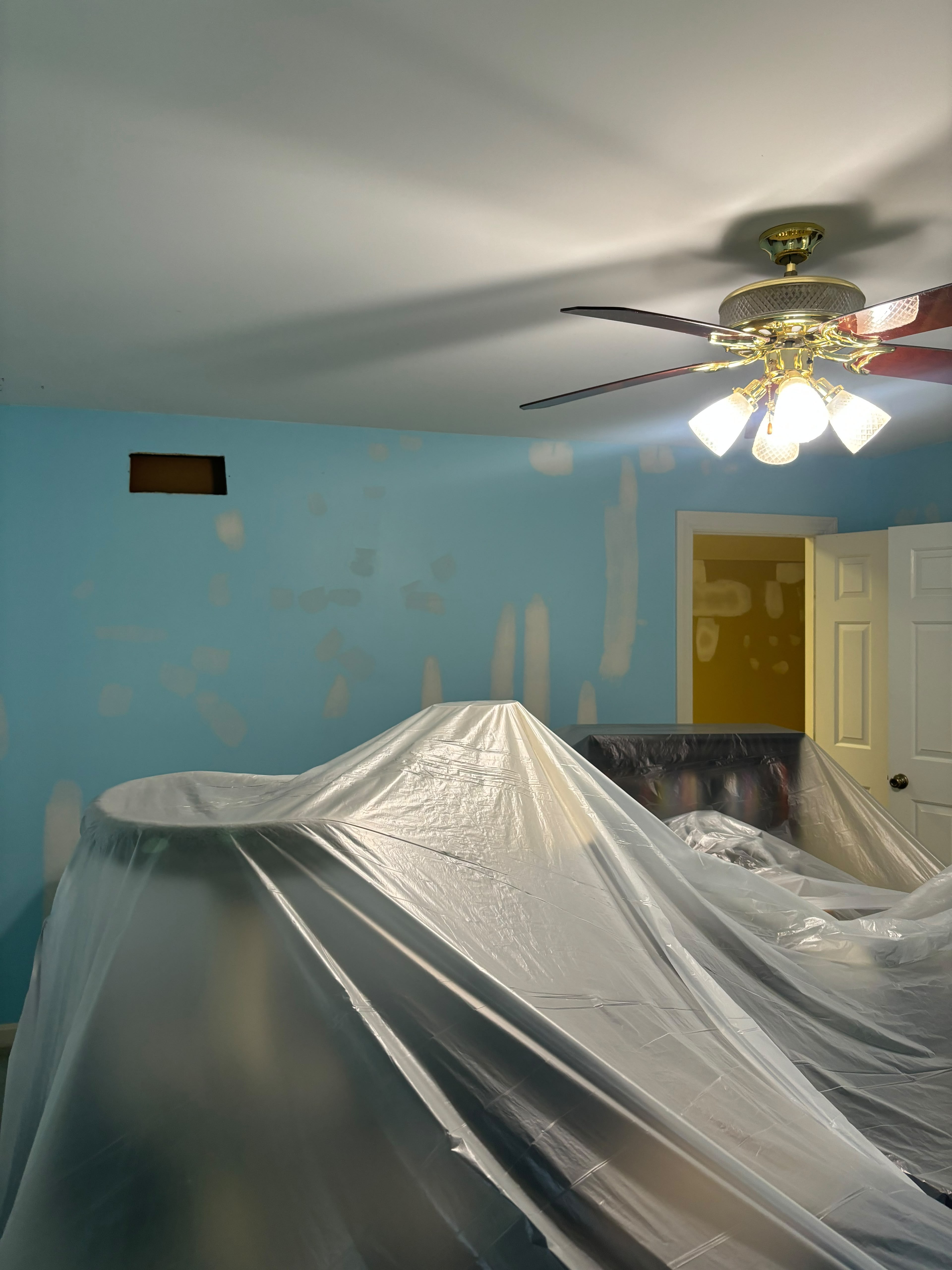 Room protected with plastic during drywall repair work in Louisville KY by ECH Professional Painting