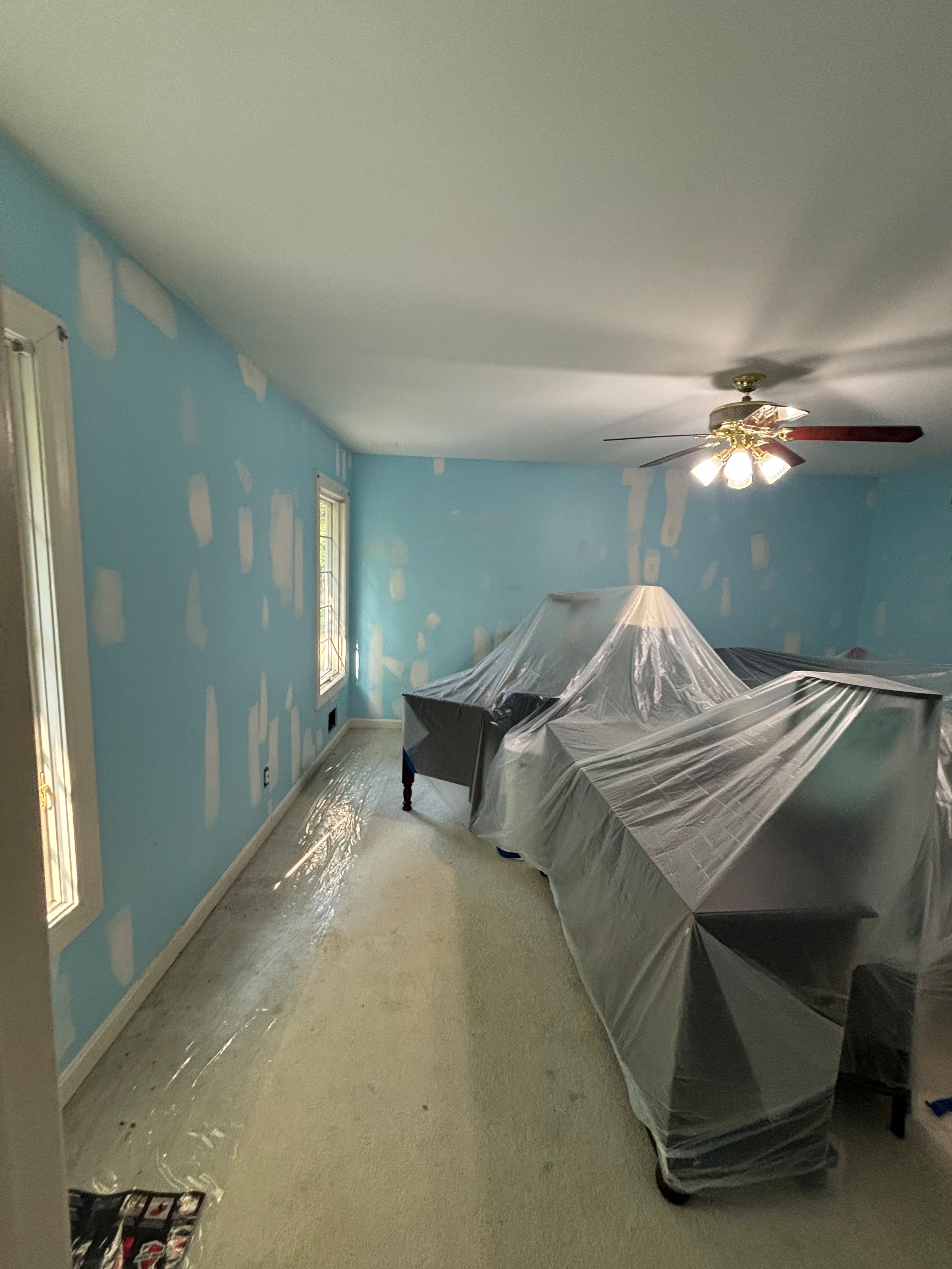 Room masked with plastic during drywall patching in Louisville KY by ECH Professional Painting