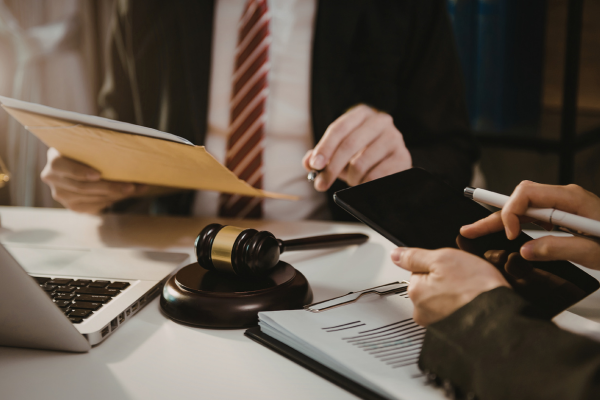 Business owner signing legal documents with lawyer Business owner signing legal documents with lawyer