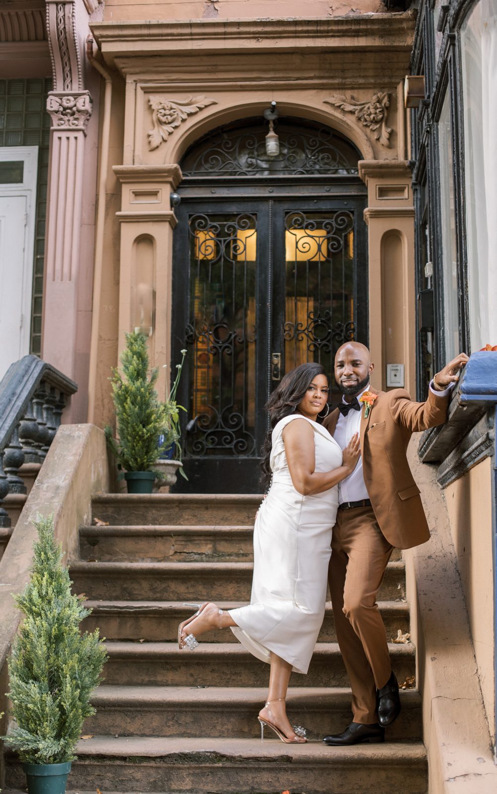 Couple sharing a first kiss beneath the Tiffany windows