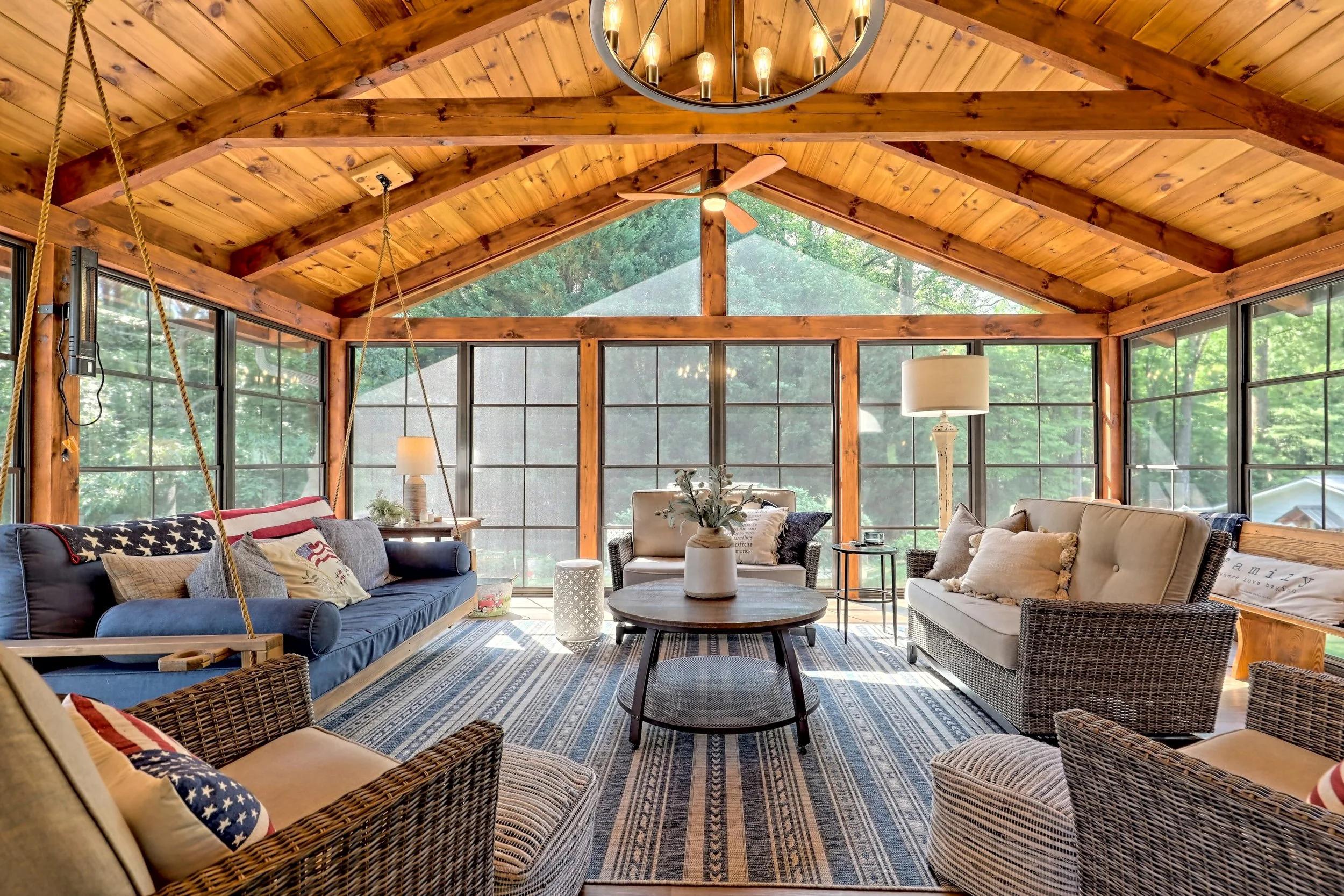 Screened-in porch with seating and wood flooring