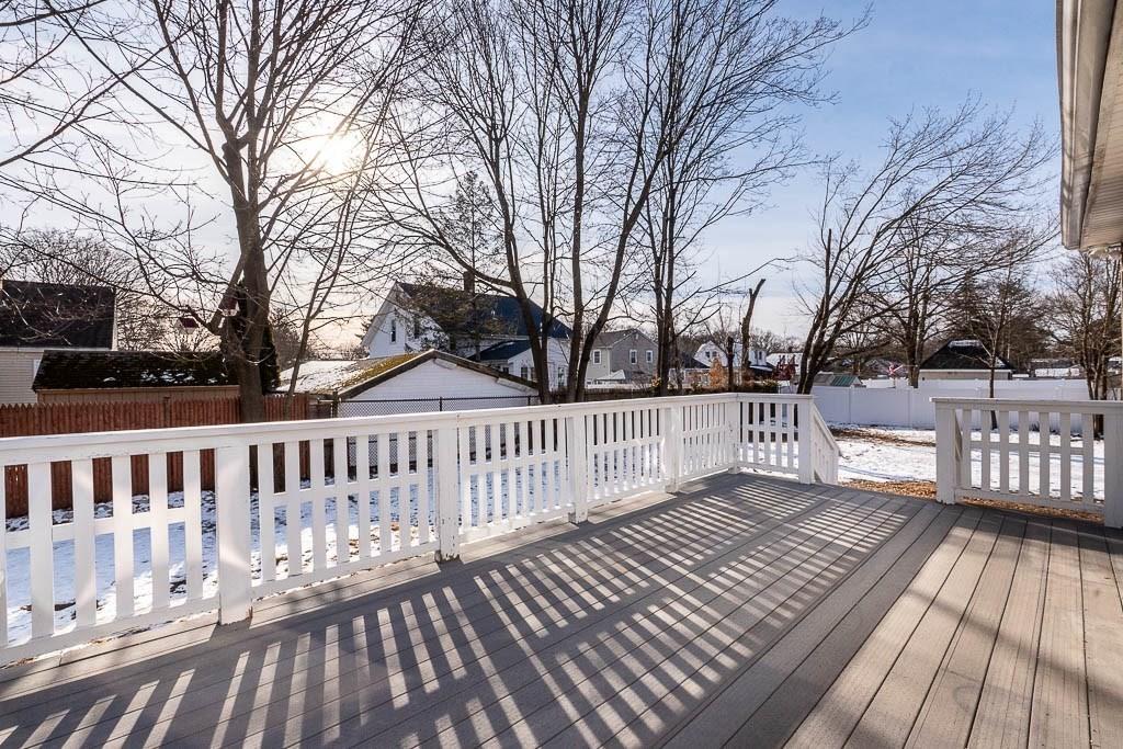 Snow-covered residential backyard deck during a Massachusetts winter