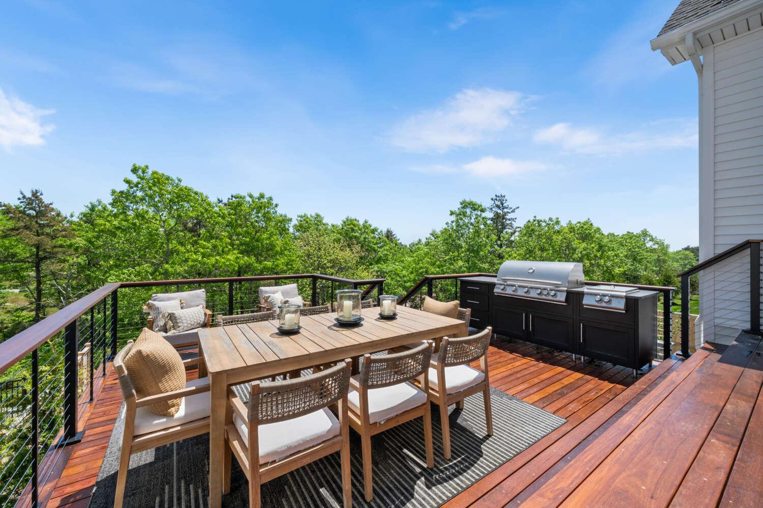 Custom residential backyard deck with outdoor dining space