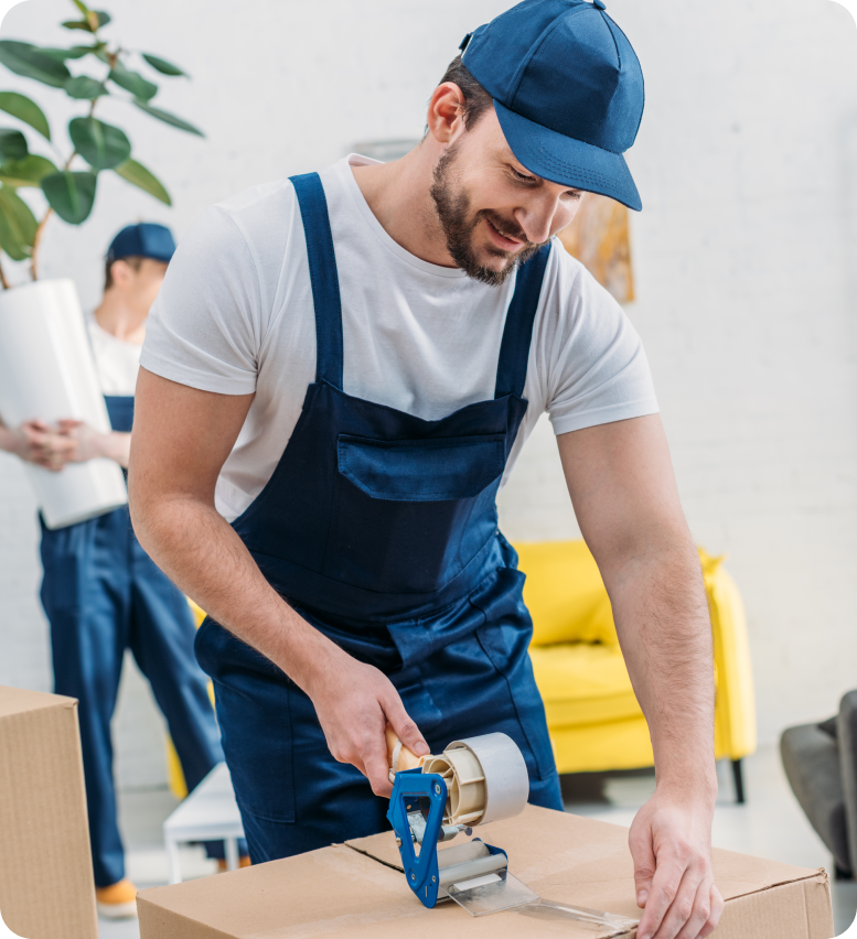 Professional packer securing items in boxes with packing materials
