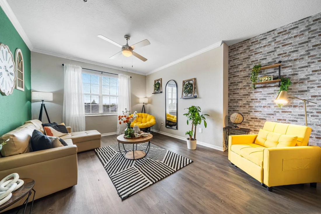 SoLiving furnished living room with a beige sofa and yellow chairs