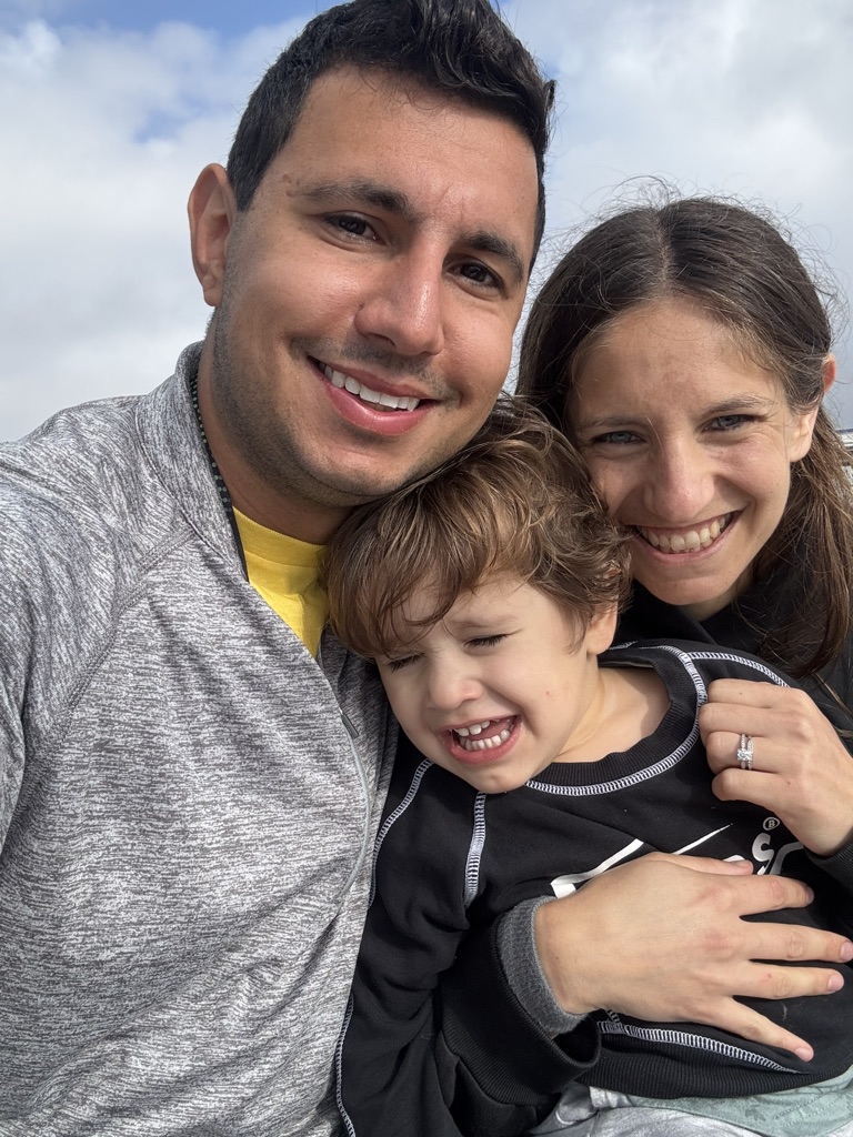 paul el zoghbi with his wife and child smiling