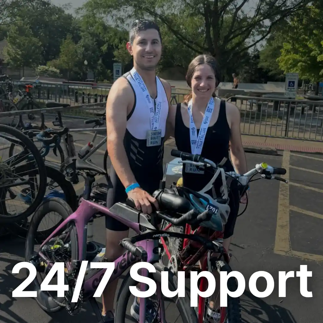 paul el zoghbi standing next to his wife after one of his triathlon races with his bike and equipment in hand