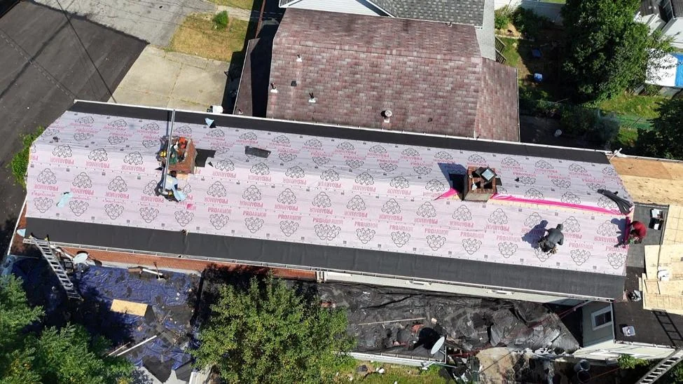 Synthetic underlayment goes down over the new sheathing. Shingles never go straight onto bare wood.