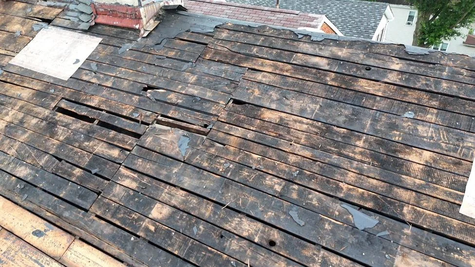 Once the shingles came off, the old roof boards underneath were rotted through.