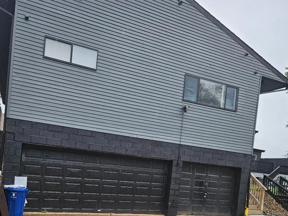 Same home after new grey siding and black garage by Cercone Exteriors