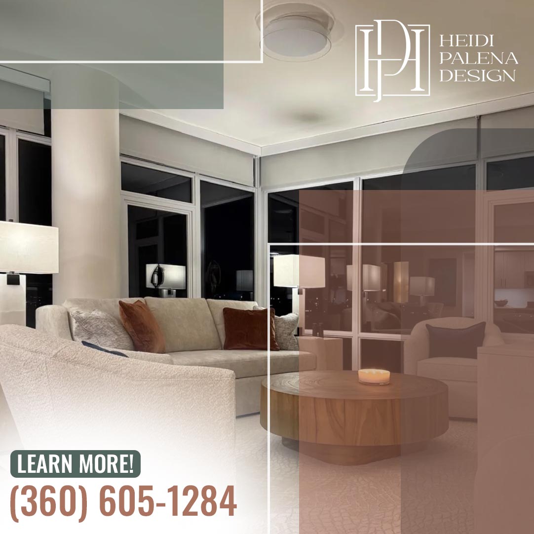 Elegant evening living room with cream sectional, wood drum coffee table, and floor-to-ceiling city-view windows