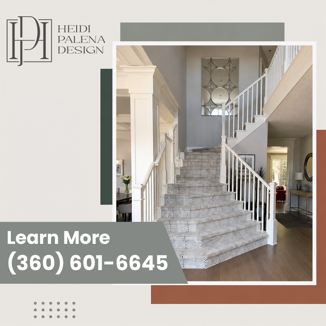 Elegant two-story home entryway featuring a wide staircase with patterned carpet runner, white balusters, craftsman columns, and hardwood flooring. Elegant two-story home entryway featuring a wide staircase with patterned carpet runner, white balusters, craftsman columns, and hardwood flooring.