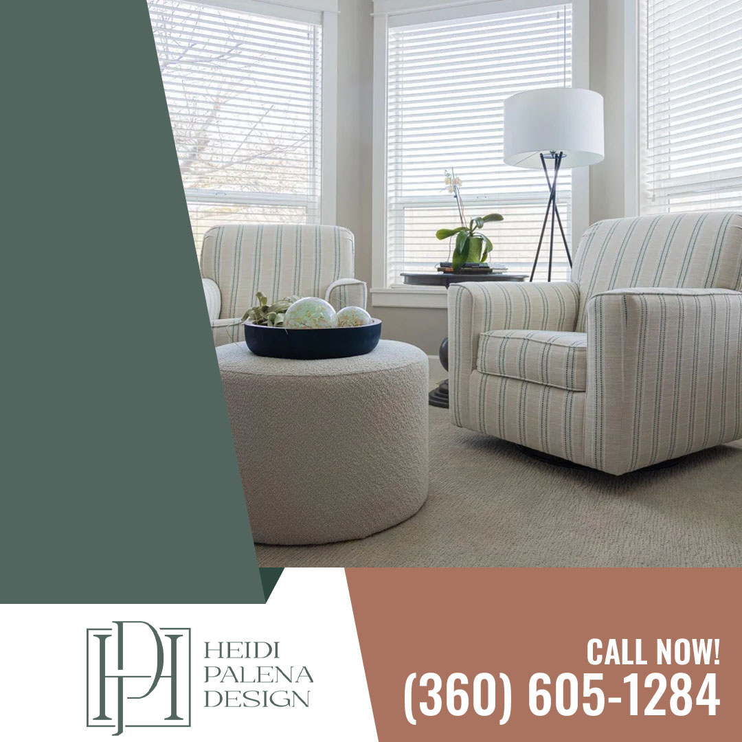 Sunlit sitting area featuring two striped upholstered armchairs, a round textured ottoman with decorative bowl, and a tripod floor lamp by large windows. Sunlit sitting area featuring two striped upholstered armchairs, a round textured ottoman with decorative bowl, and a tripod floor lamp by large windows.