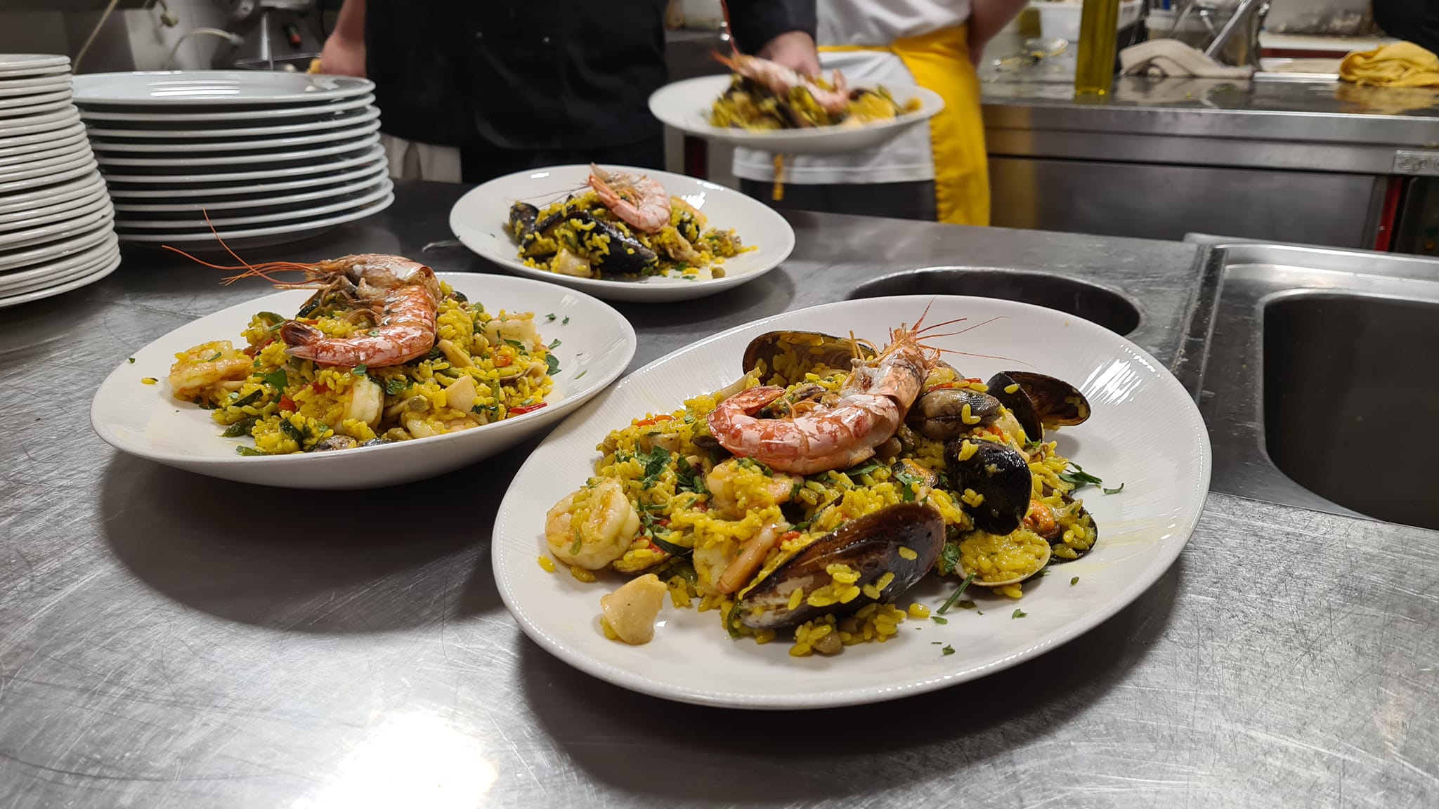 Paella di pesce impiattata in cucina