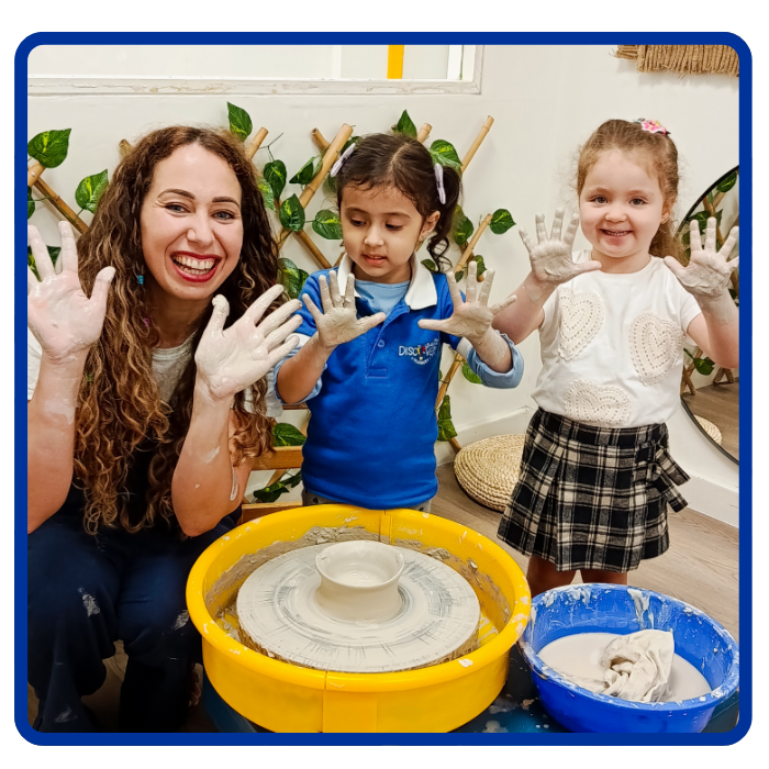 childen and teacher doing pottery showing hands