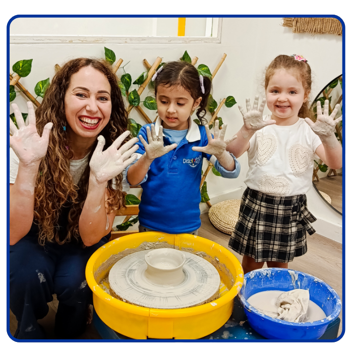 childen and teacher doing pottery showing hands