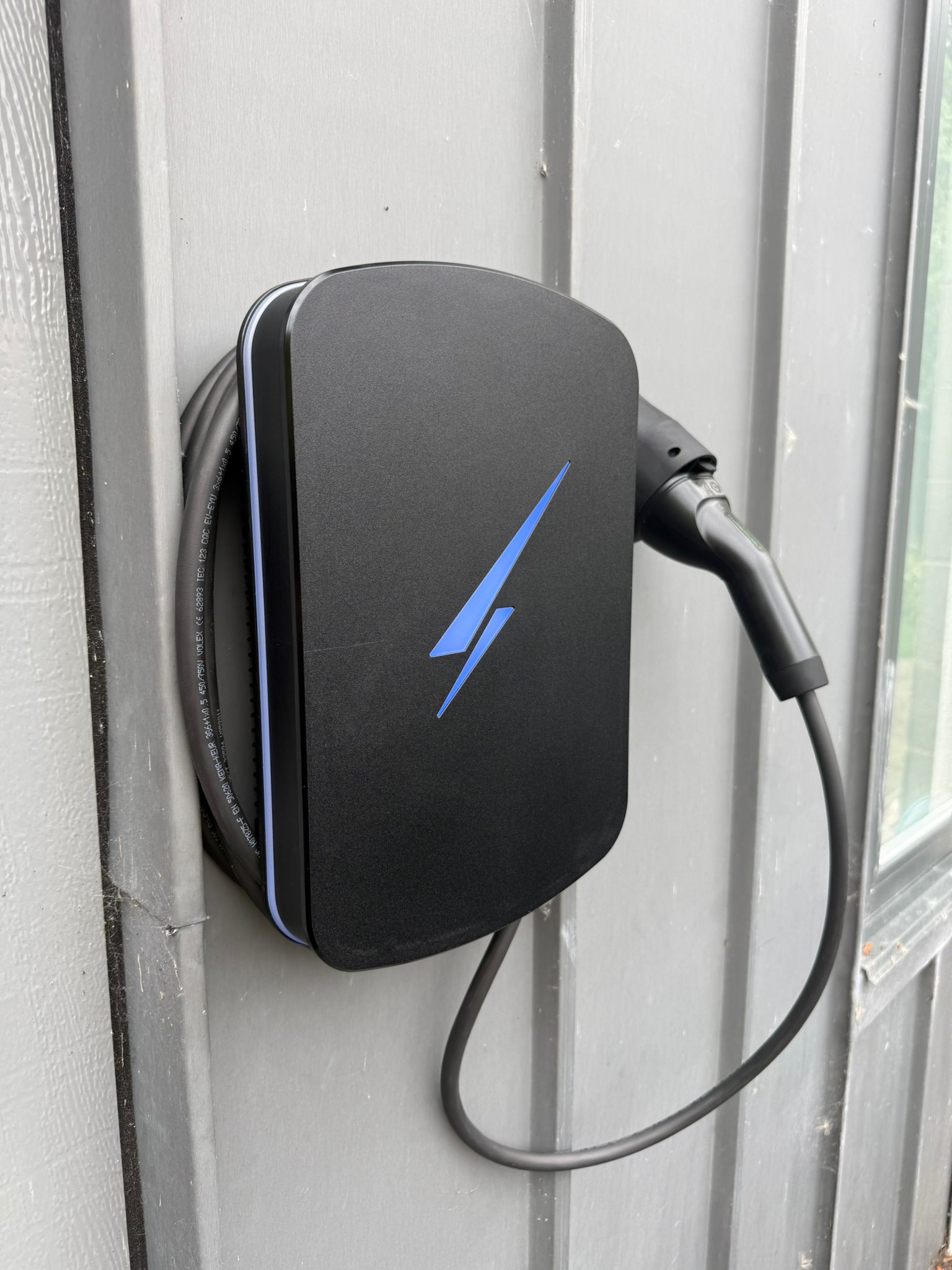 Black EV wall charger installed by Blackline Electrical