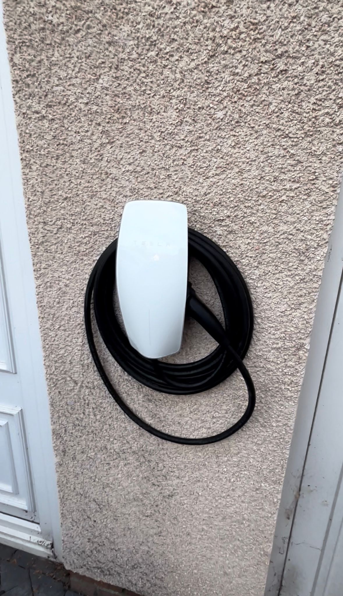 White EV charger with neatly stored cable installed by Blackline Electrical