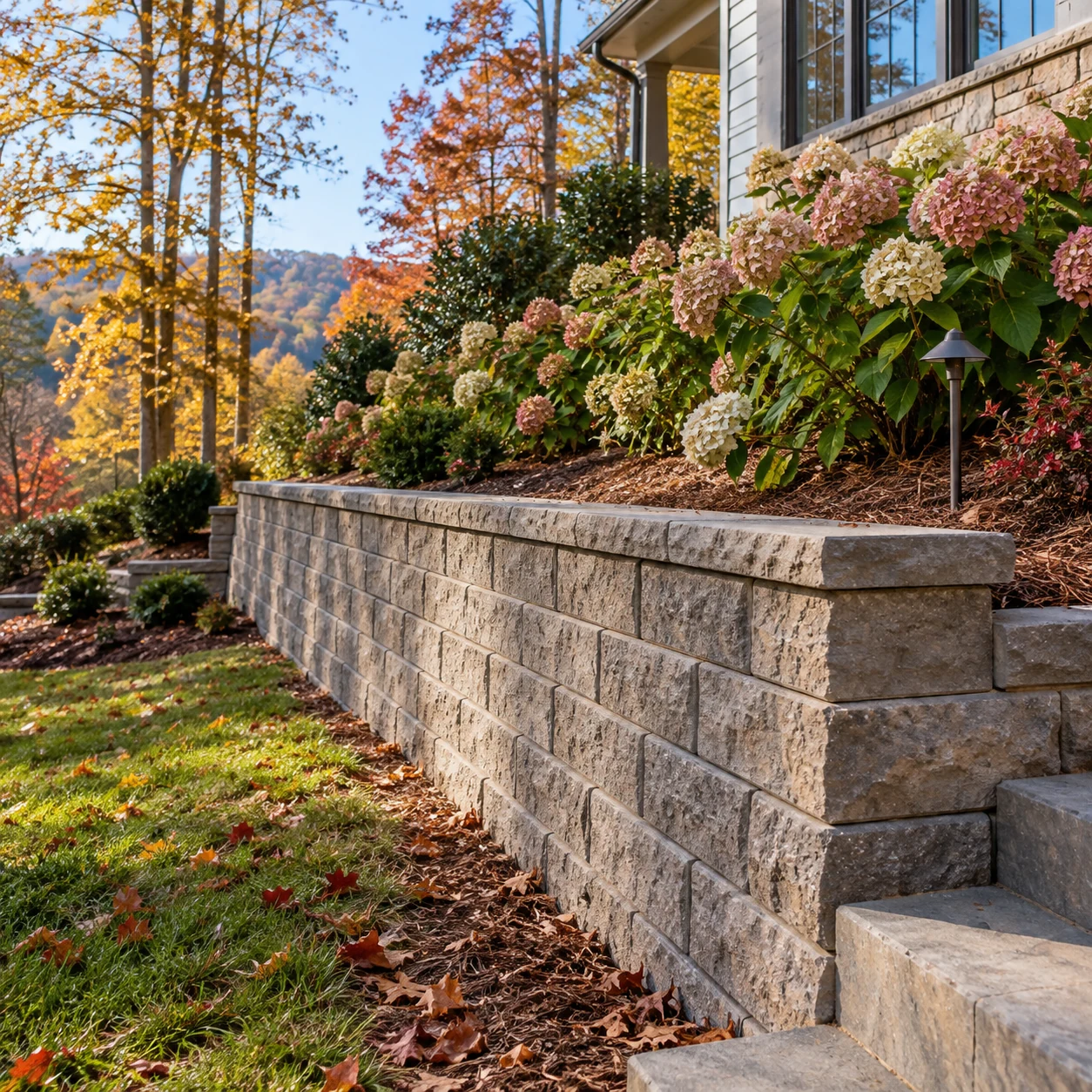 a concrete block landscape retaining wall supporting a residential planted slope
