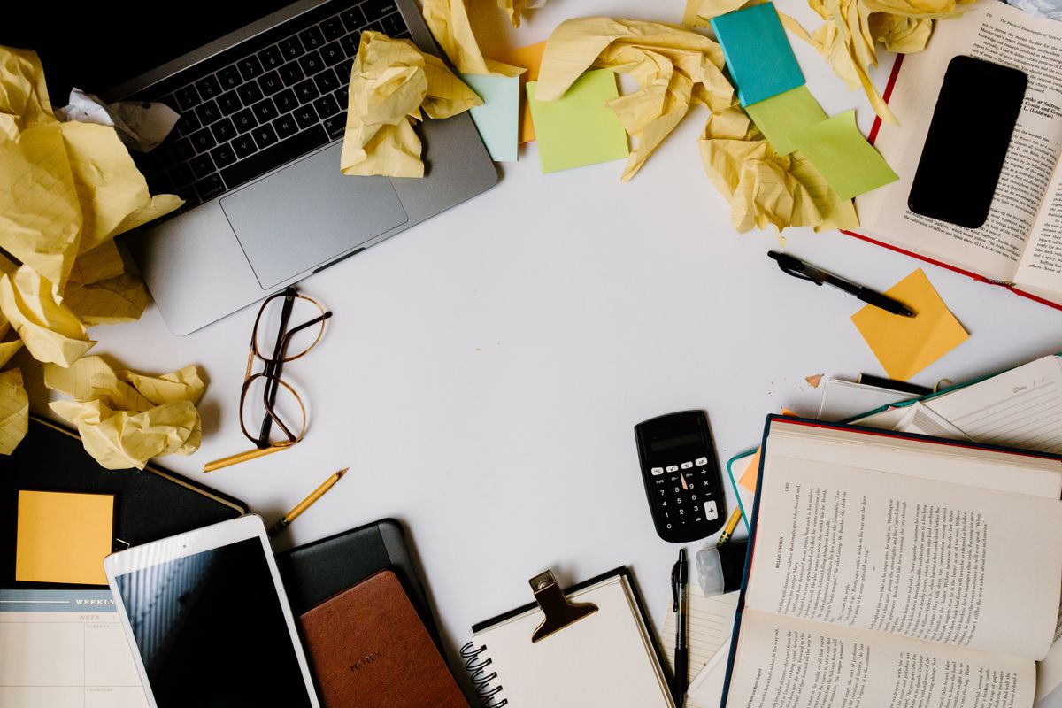 Cluttered office desk before cleaning