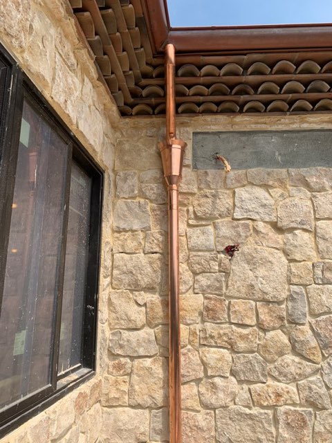 Clean installation of a white metal rain gutter on a residential home