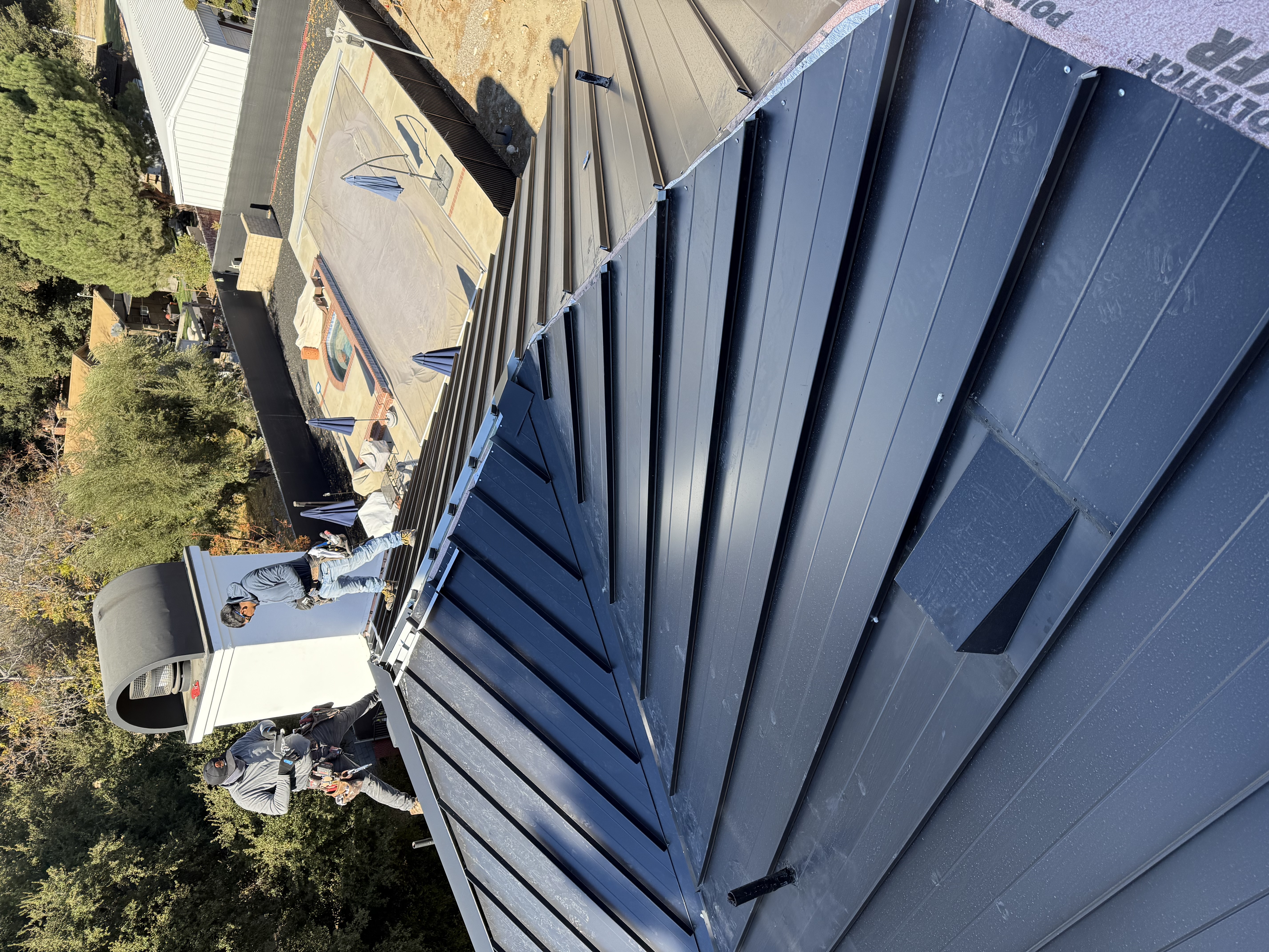 Installed metal roof panel system on a property