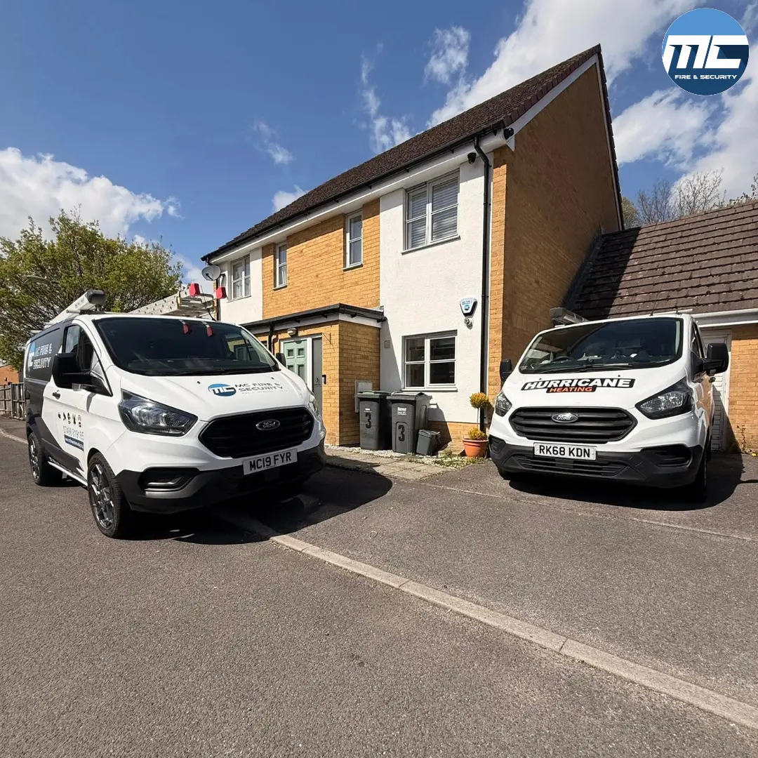 Two MC Fire & Security branded vans on a CCTV installation in Cornwall