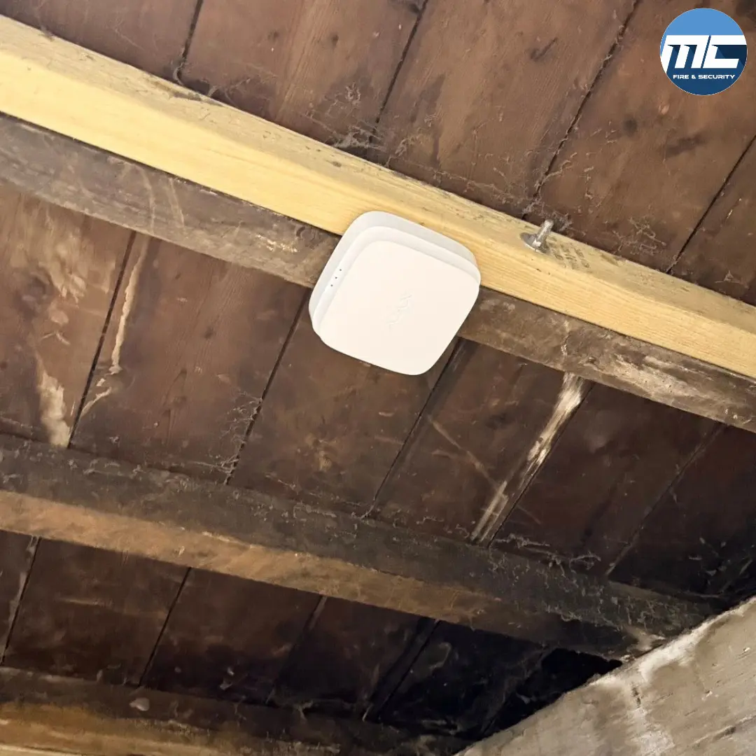 Wireless fire detector on a Cornish timber-beam and slate ceiling