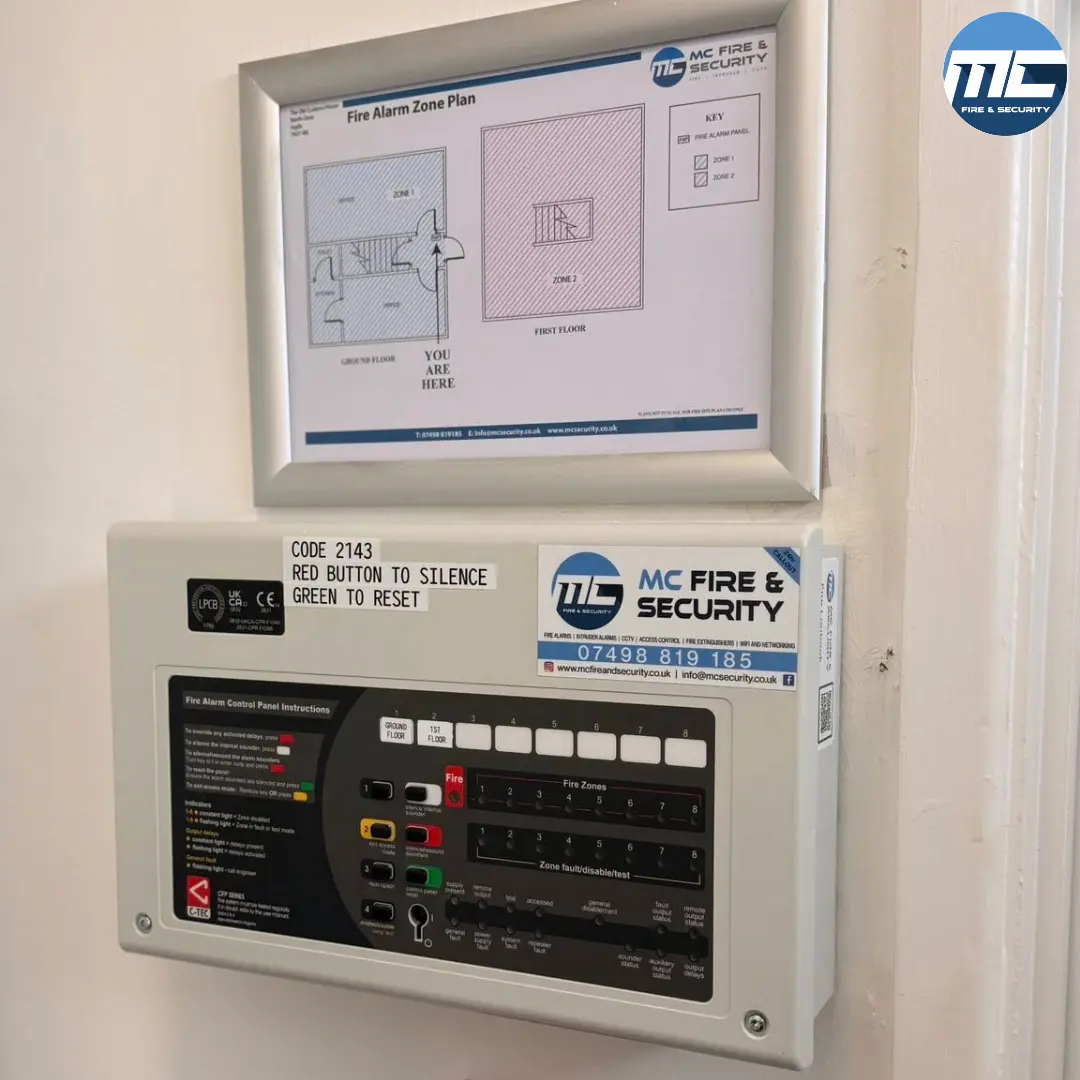MC Fire & Security branded fire alarm panel with zone plan above