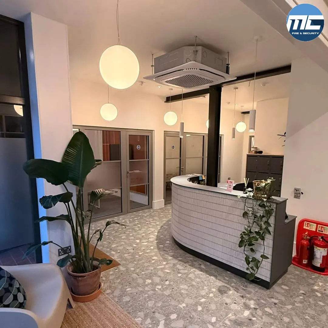 Modern reception with emergency-lighting compliant pendant lighting