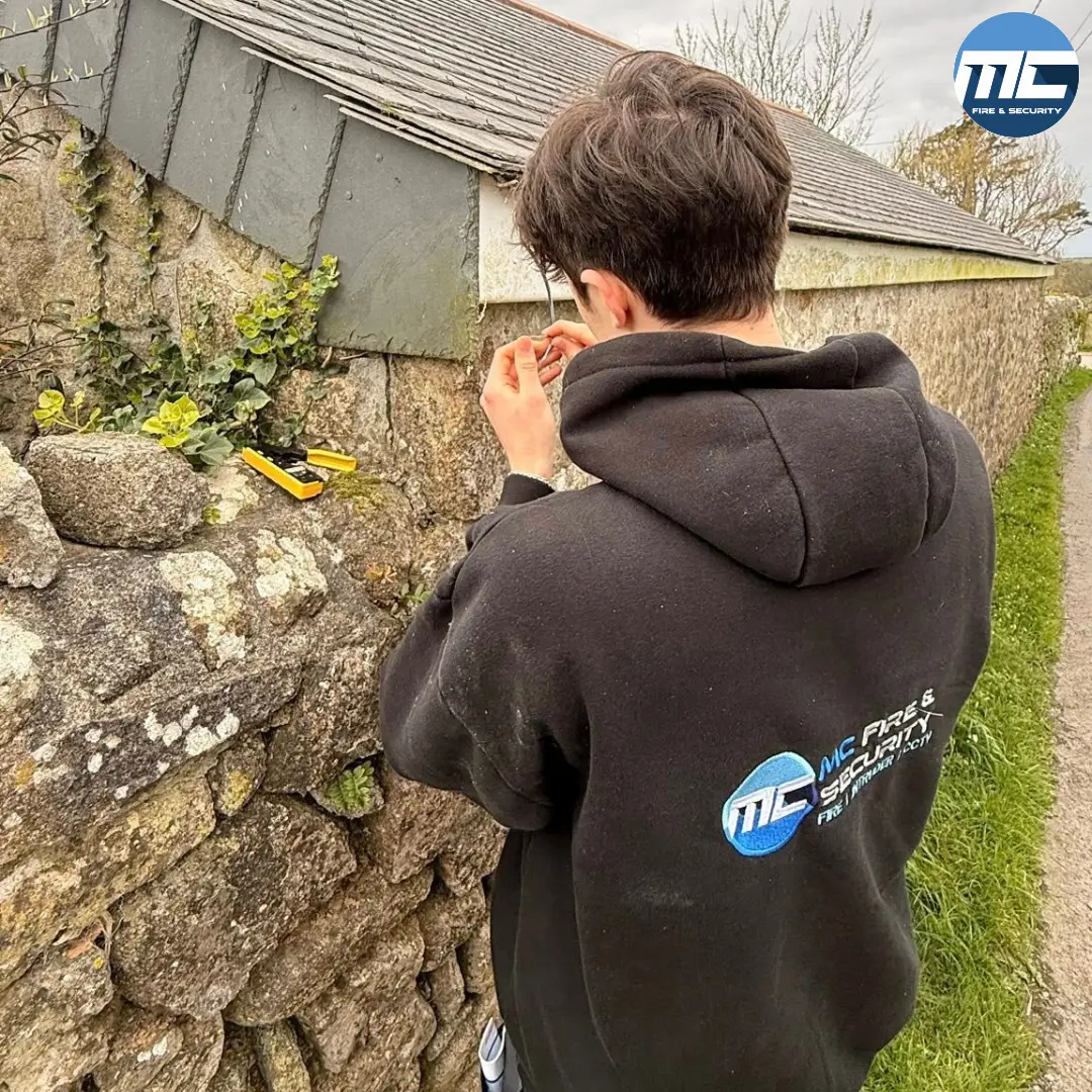 MC Fire & Security engineer working on a Cornwall granite-walled property