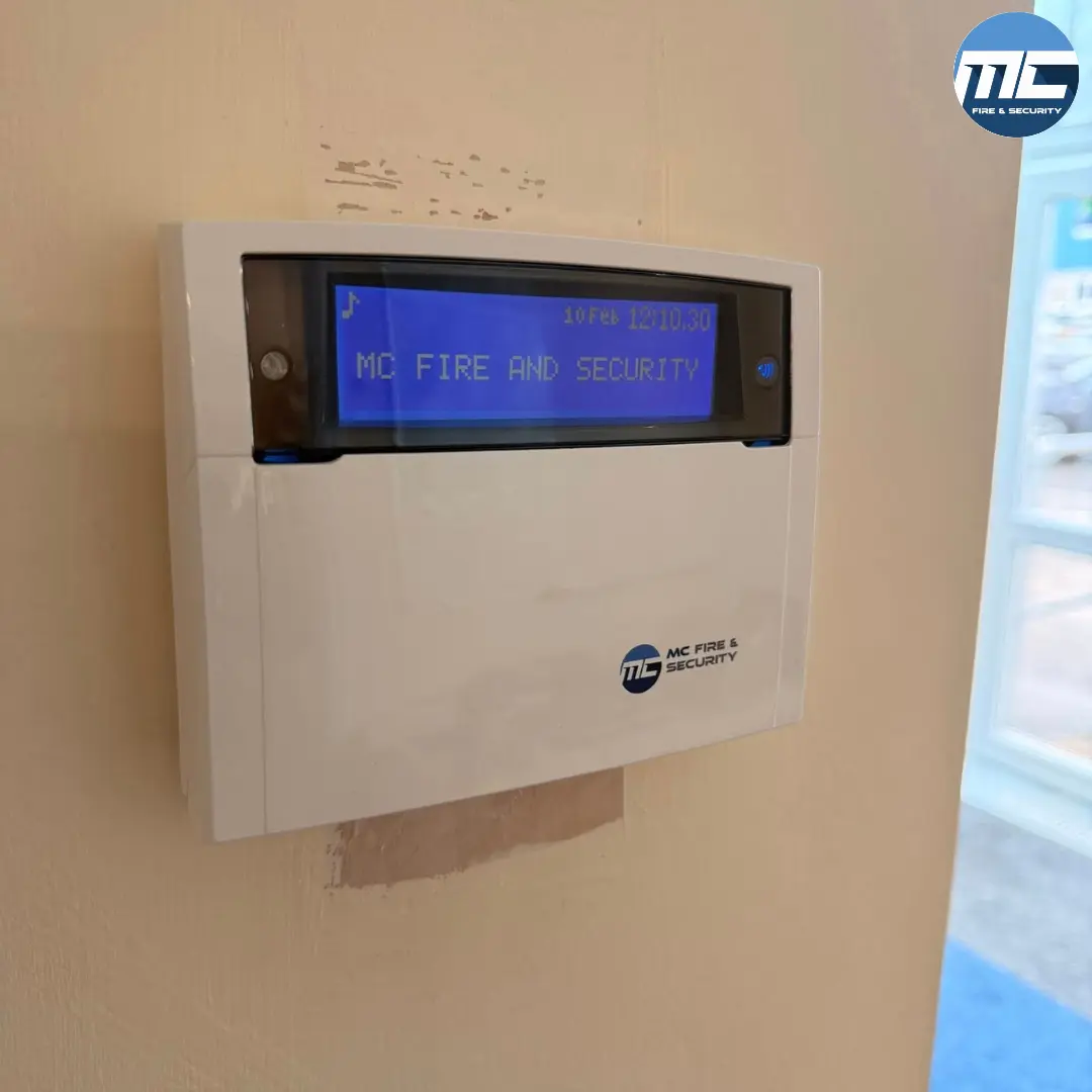 MC Fire & Security intruder alarm keypad showing system status