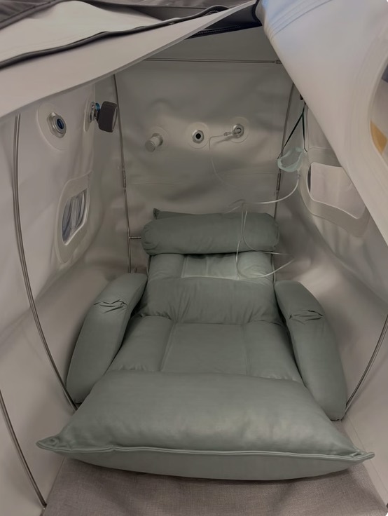 The padded reclining seat inside a hyperbaric chamber
