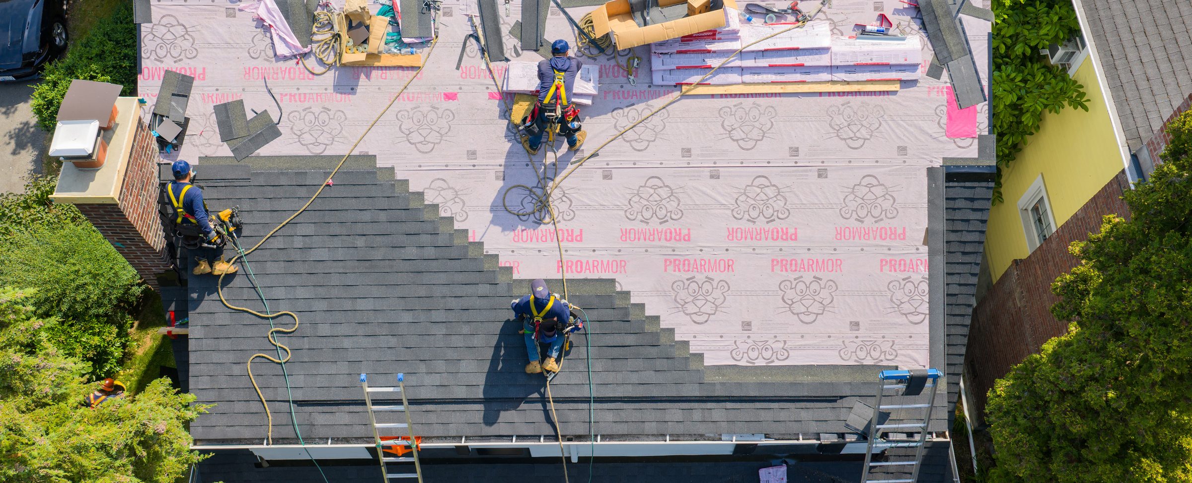 Guardian Roofing crew installing a new roof, seen from above